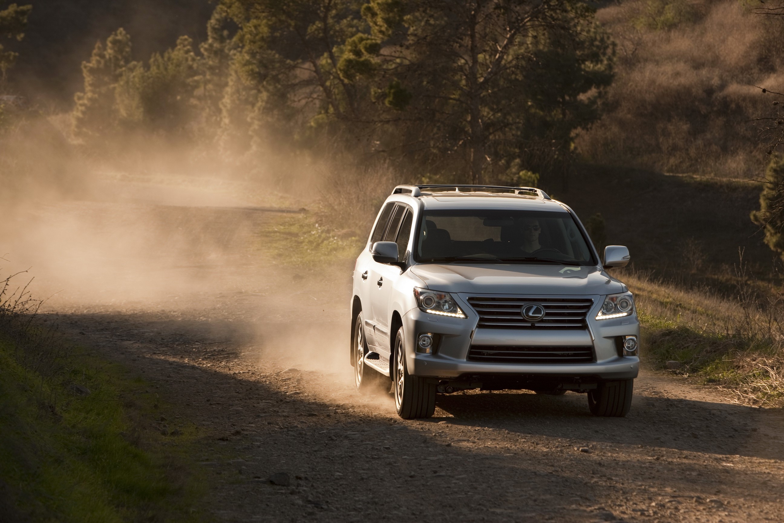 2012 Lexus LX 570 driving on a dusty road HD Wallpaper