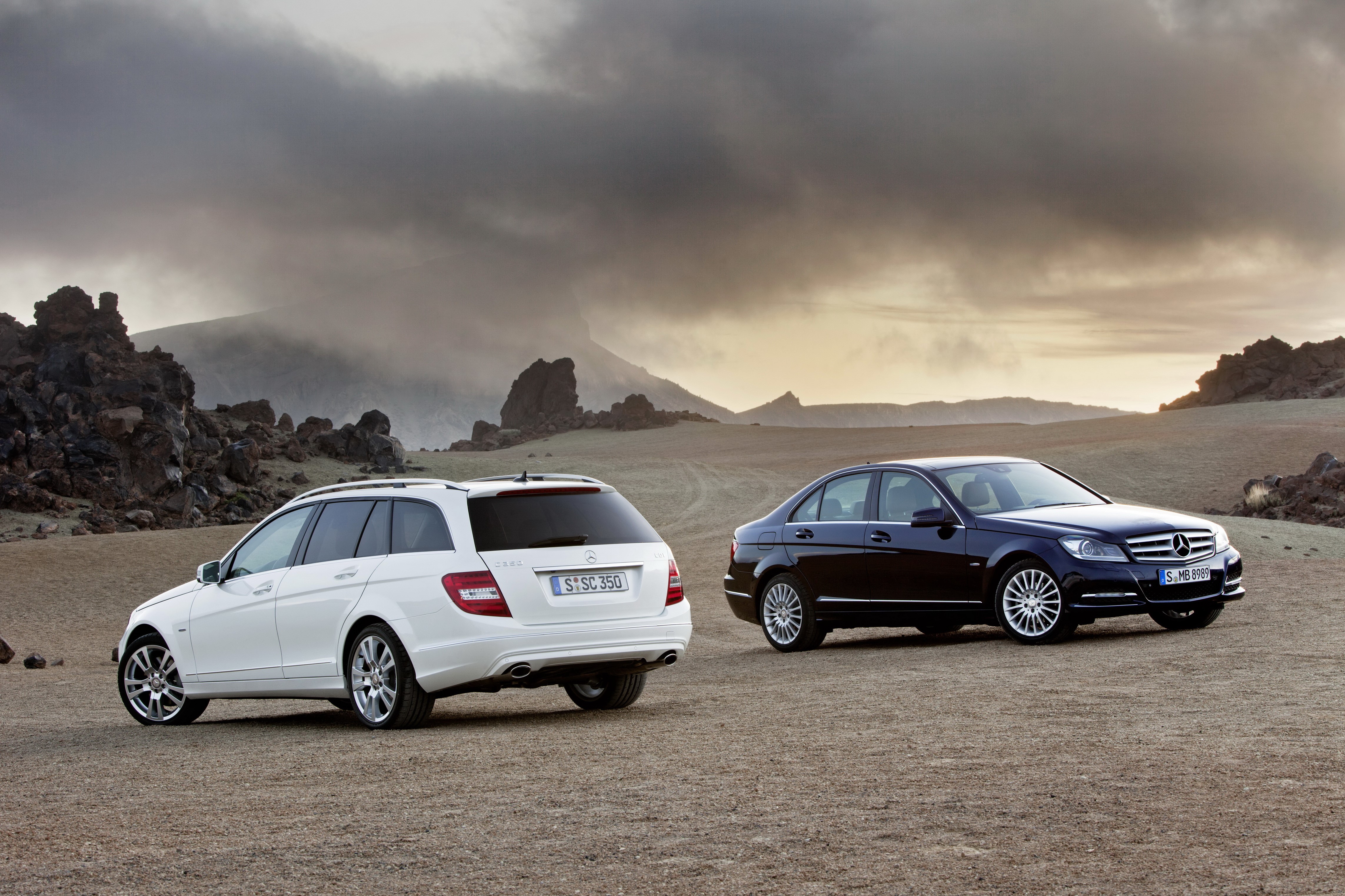 Two Mercedes-Benz cars in a rocky landscape HD Wallpaper