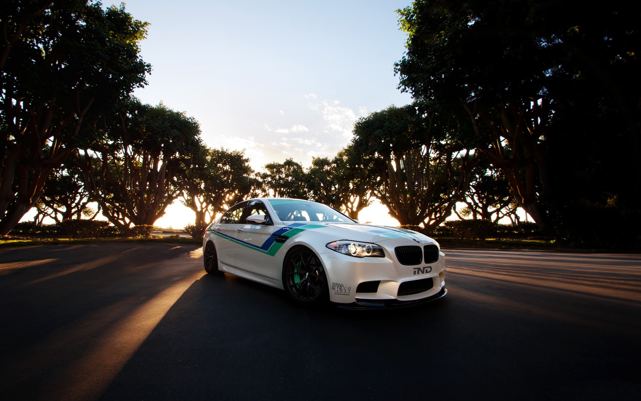 White BMW M5 with racing stripes HD Wallpaper