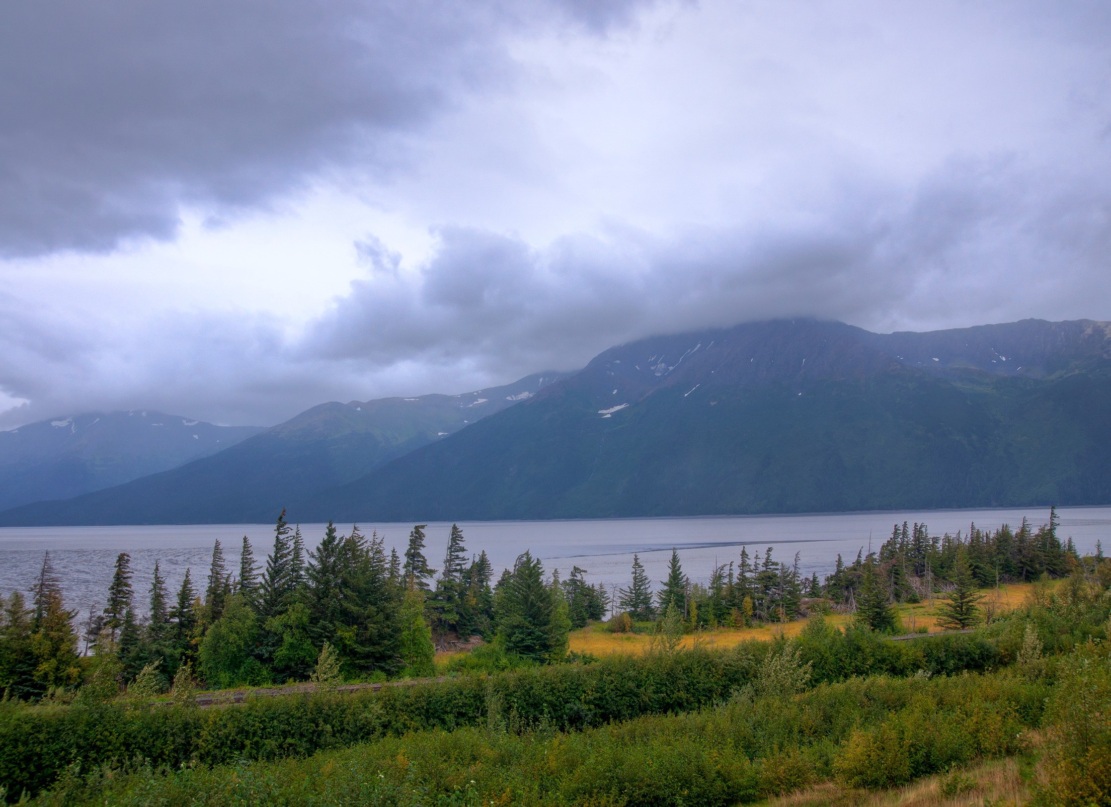 Mountains and lake in Alaska under cloudy sky HD Wallpaper