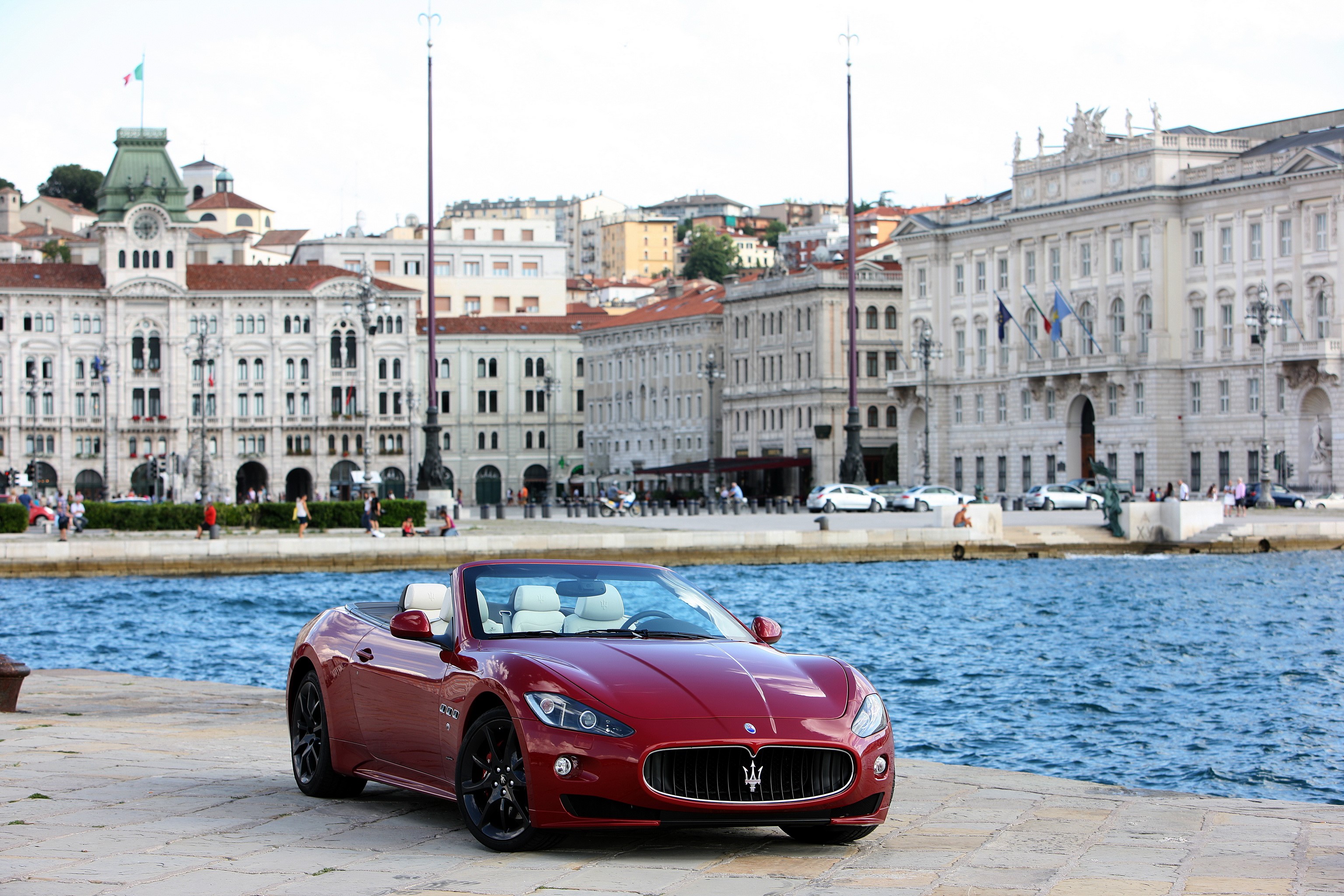 Red Maserati GranCabrio Sport convertible parked by the water HD Wallpaper