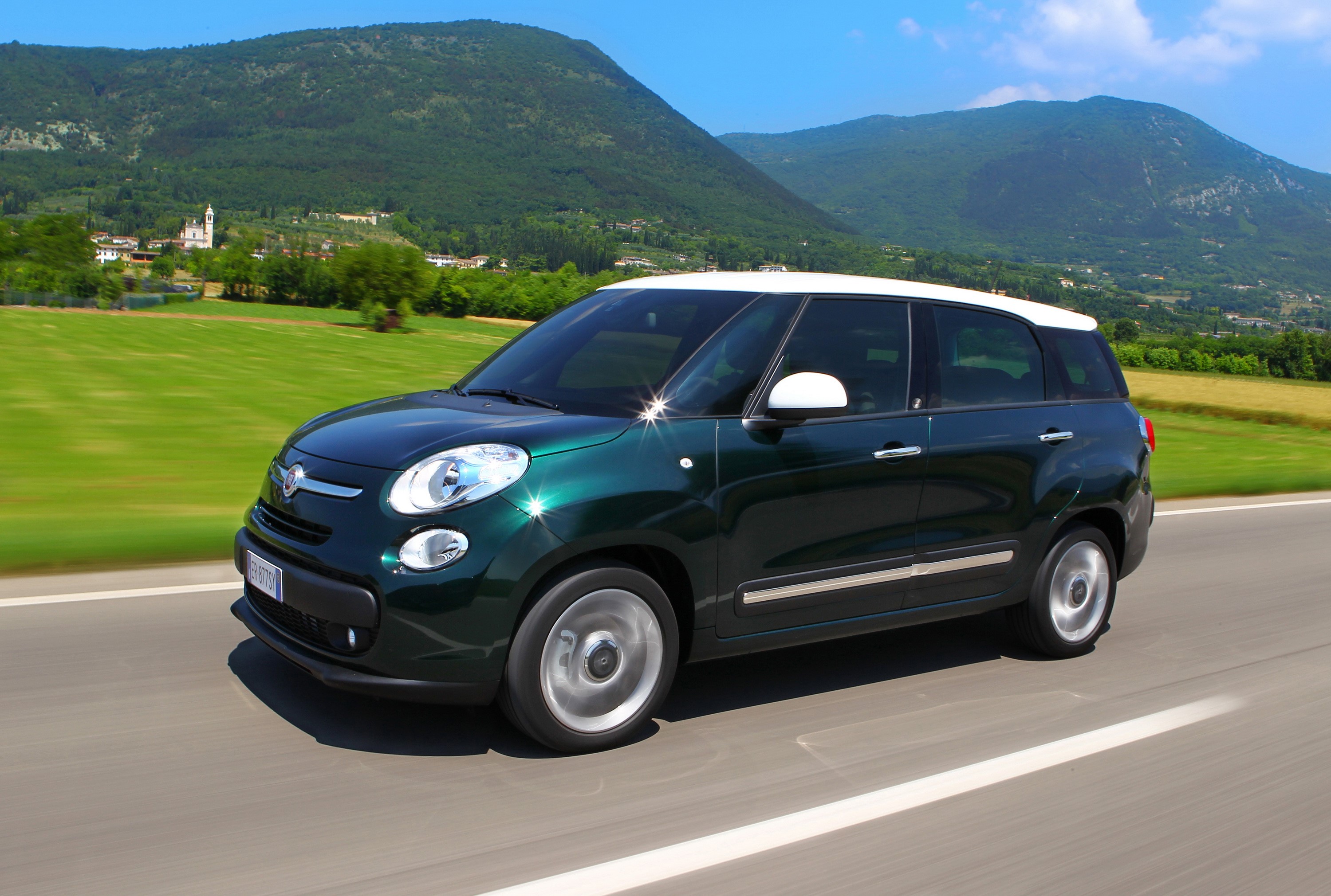 2013 Fiat 500L Living driving on a road with mountains HD Wallpaper