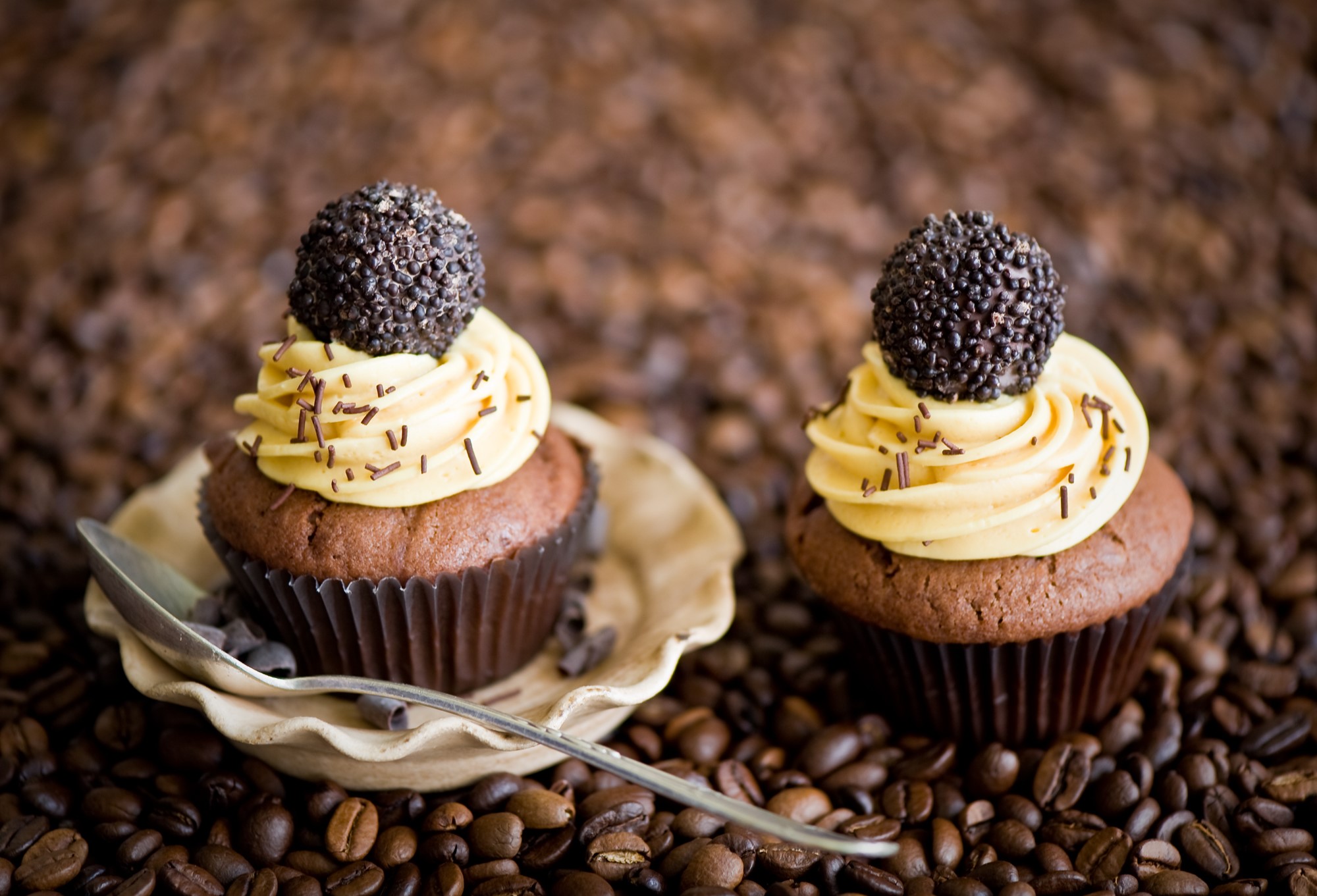 Two chocolate cupcakes with coffee frosting and sprinkles HD Wallpaper