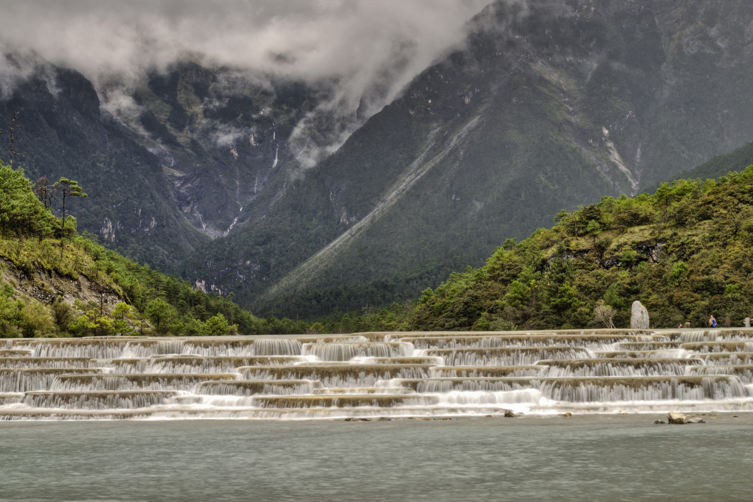 Terraced waterfalls in Lijiang, China with mountains HD Wallpaper