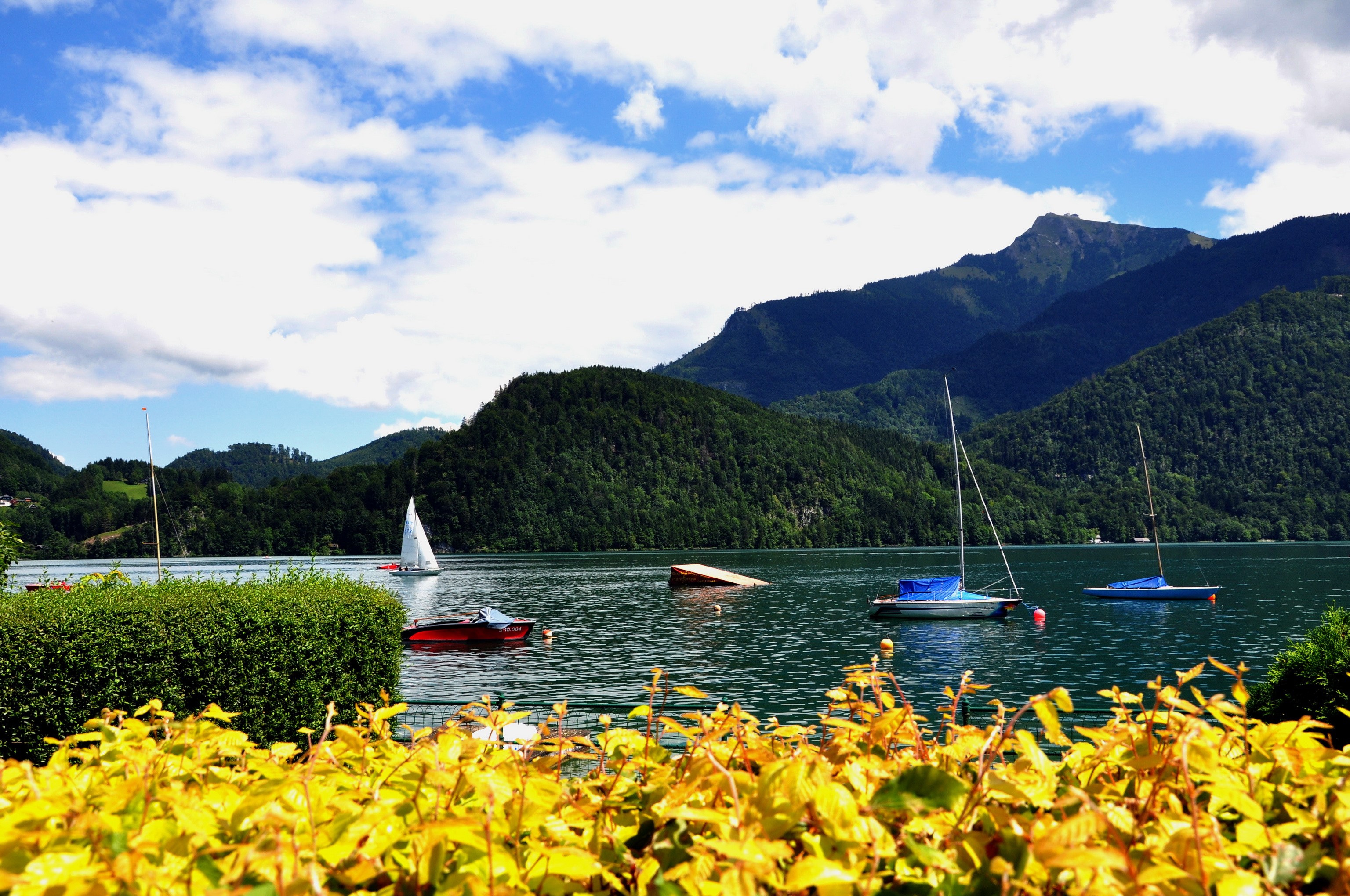 Boats on a lake with mountains in Austria HD Wallpaper