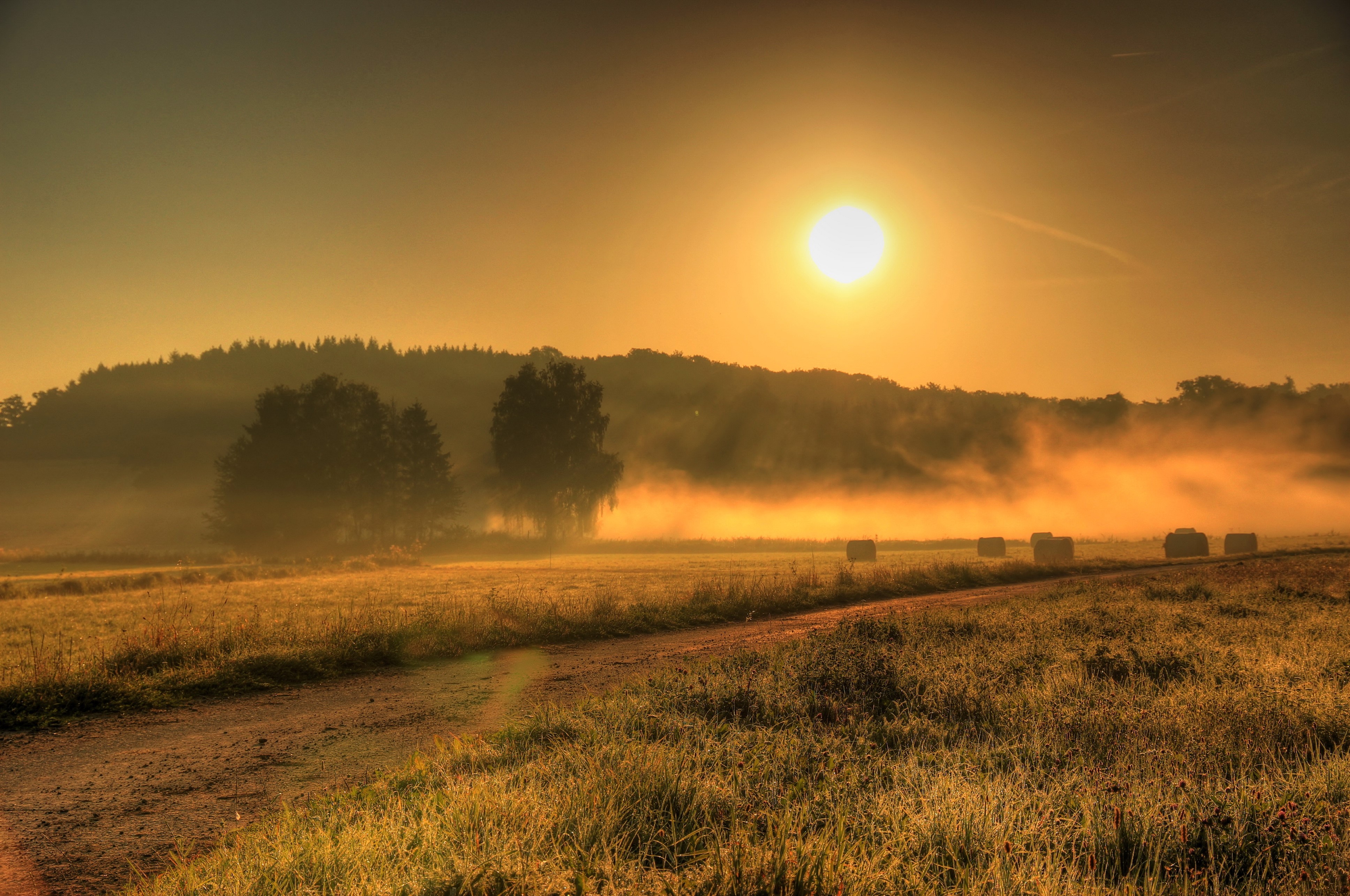 Foggy German Field at Sunrise with Hay Bales HD Wallpaper