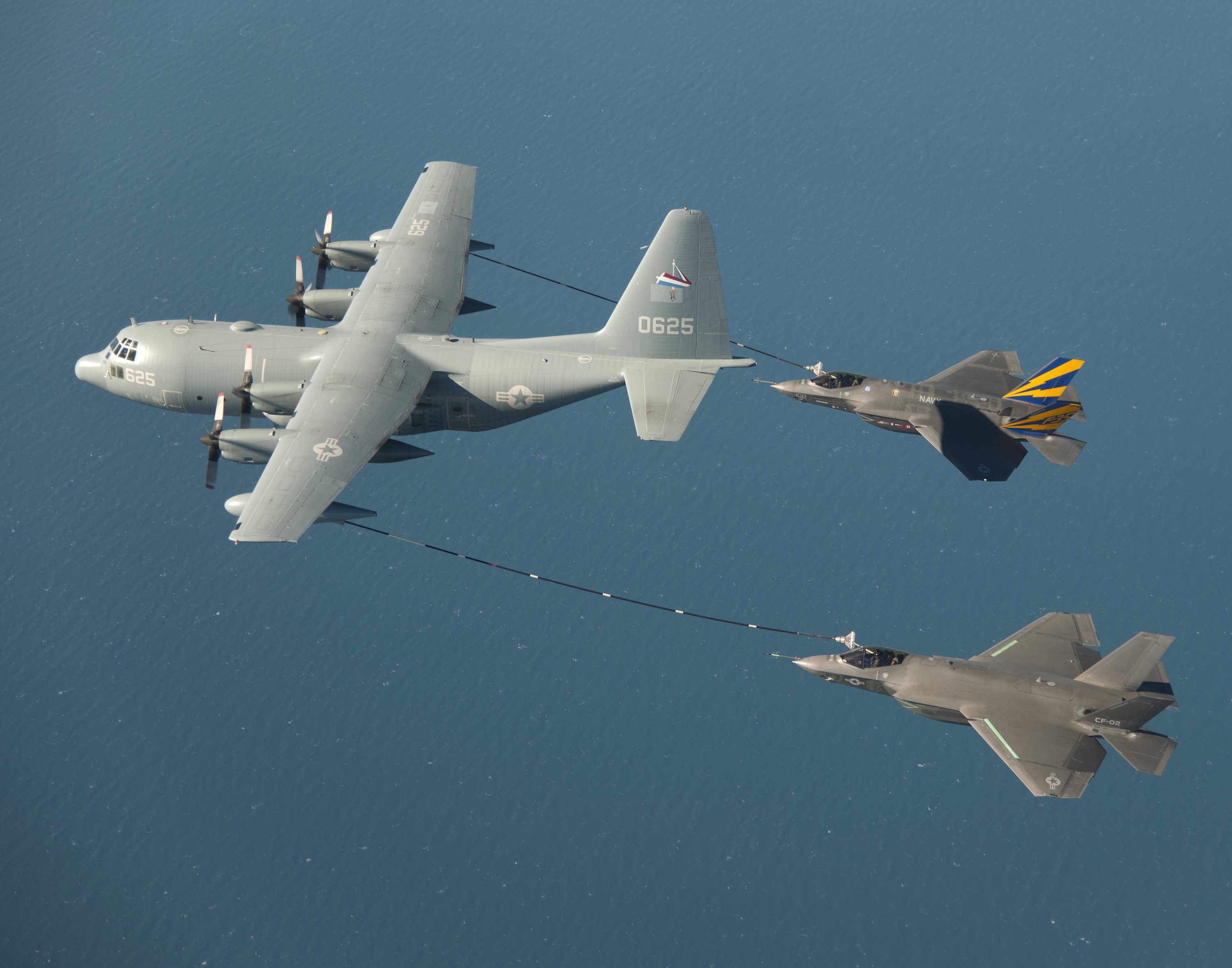 KC-130 refueling two F-35 fighter jets HD Wallpaper