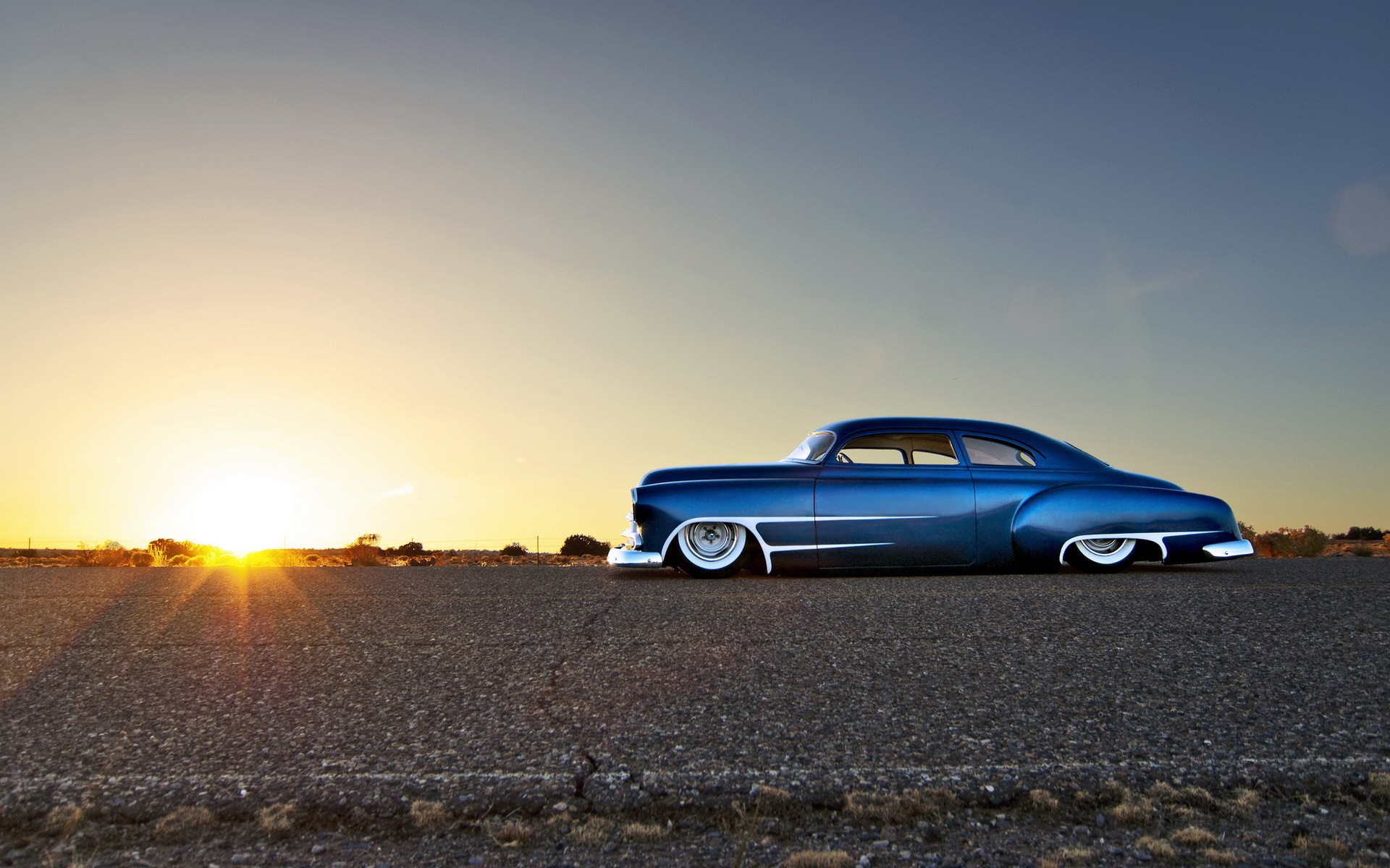 Blue hot rod car parked on asphalt road at sunset HD Wallpaper