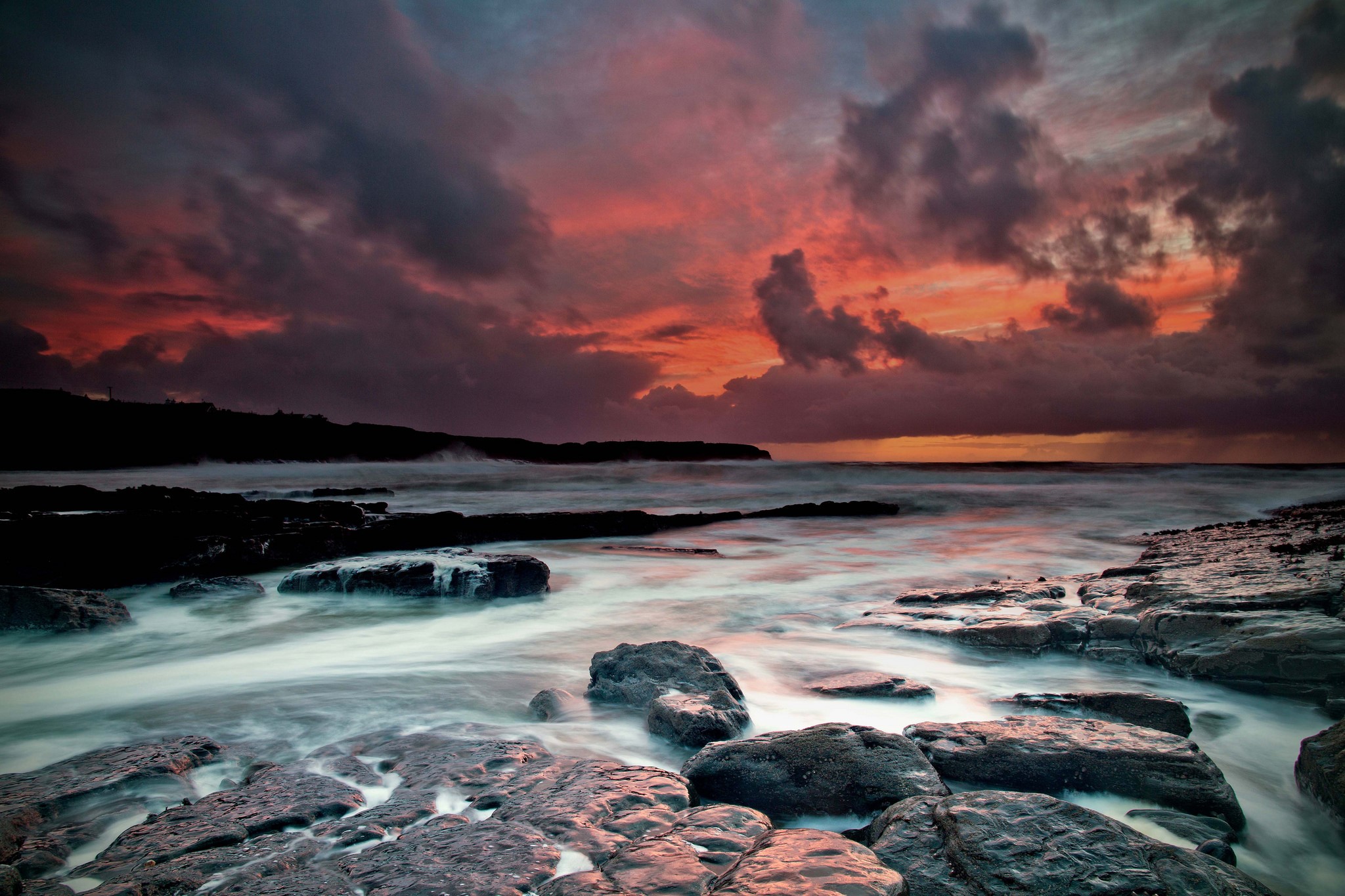 Dramatic sunset over rocky coast and sea in Ireland HD Wallpaper