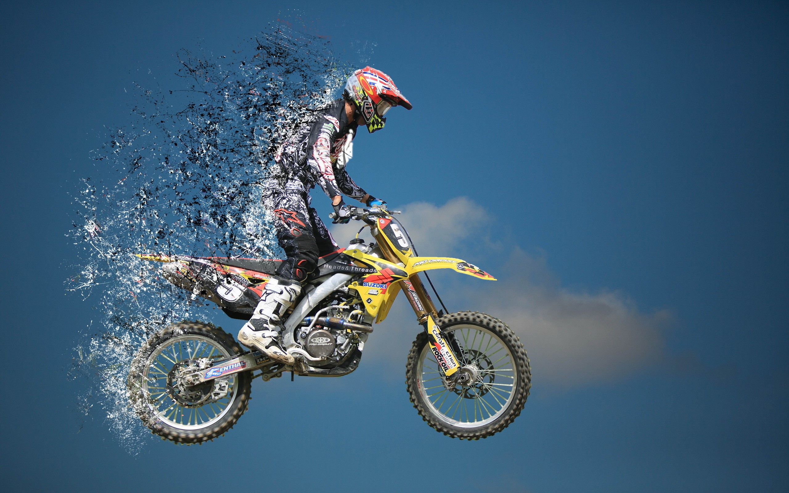 Motocross rider in mid-air with digital disintegration effect HD Wallpaper