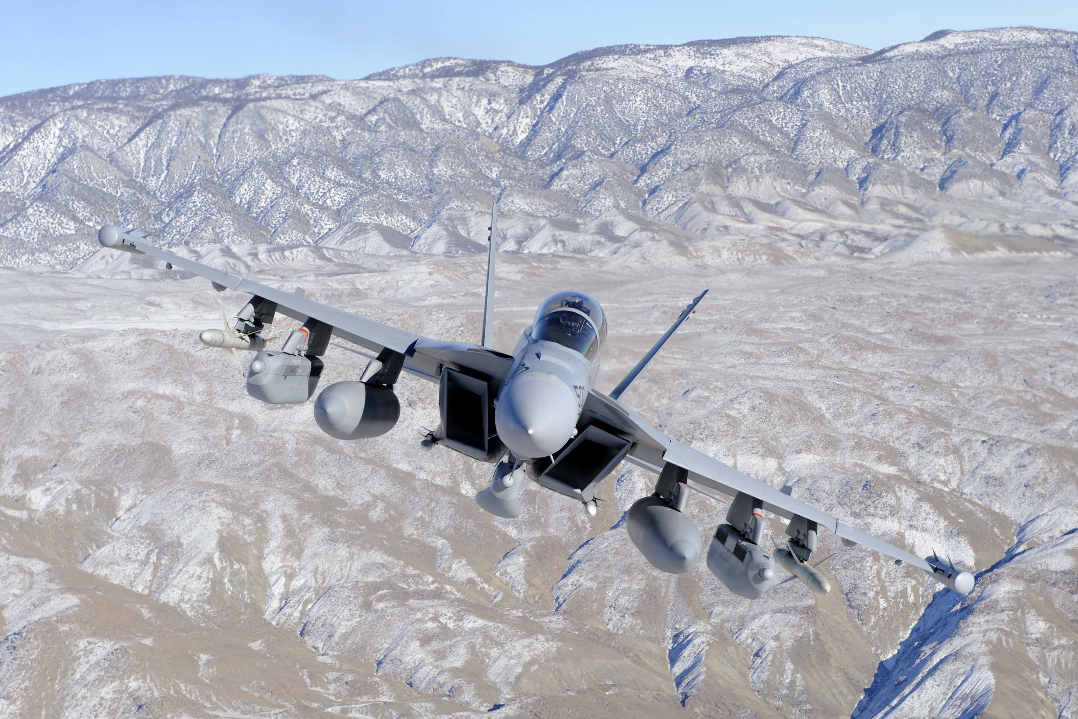 EA-18G Growler flying over snowy mountains HD Wallpaper