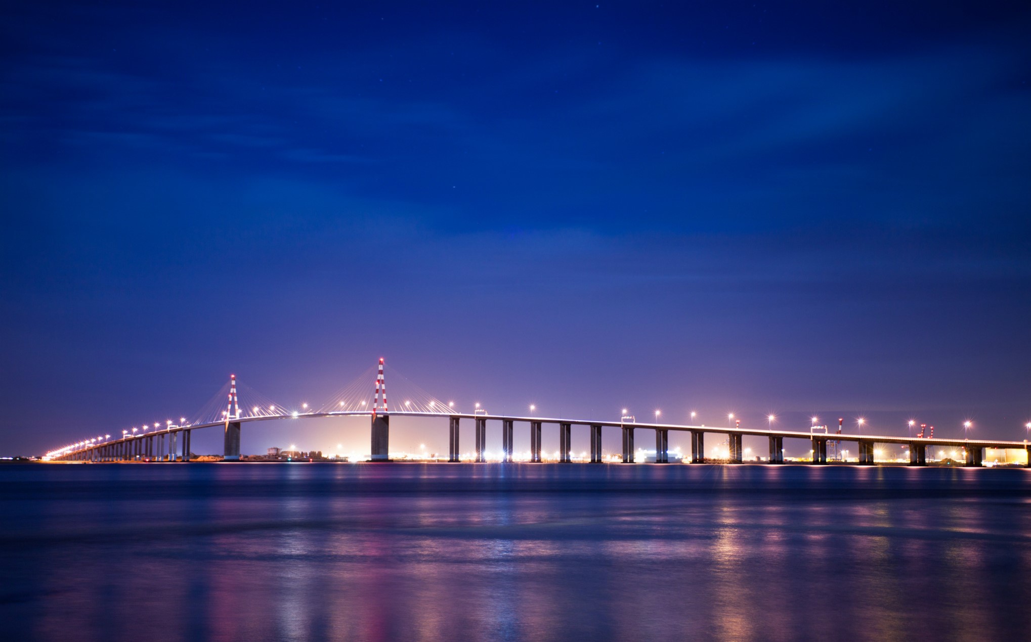 Bridge over water at night with lights HD Wallpaper