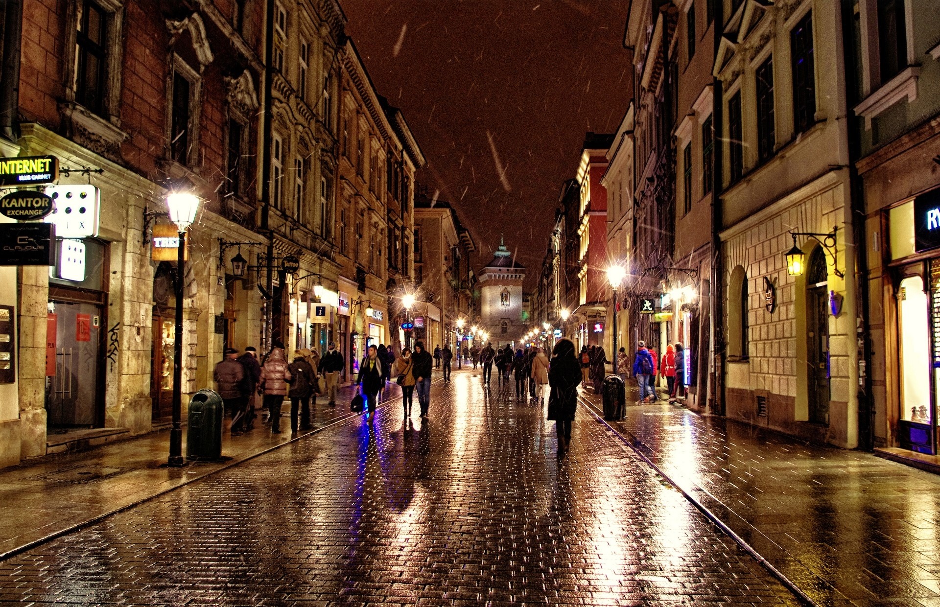 People walking on a wet street at night in Poland HD Wallpaper
