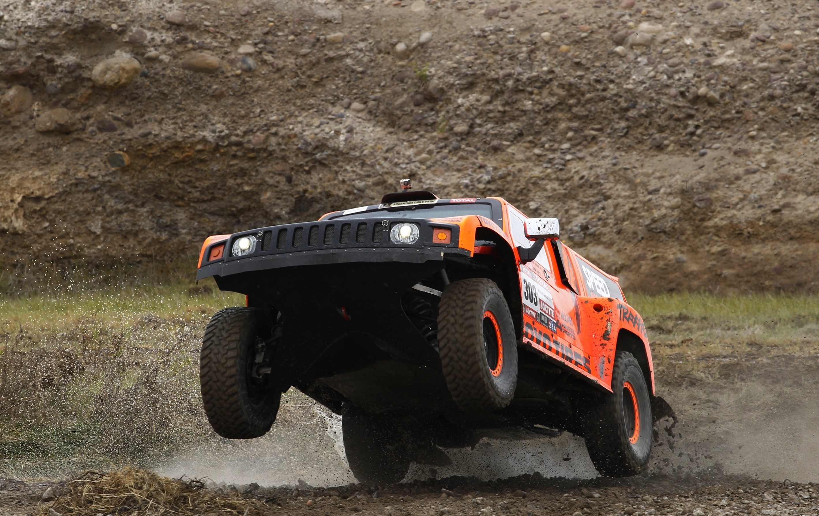 Orange Hummer racing vehicle jumping over water HD Wallpaper