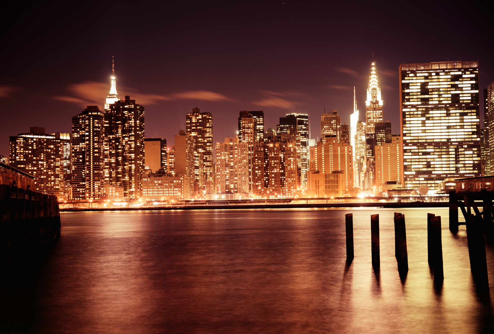 New York City skyline at night over the water HD Wallpaper