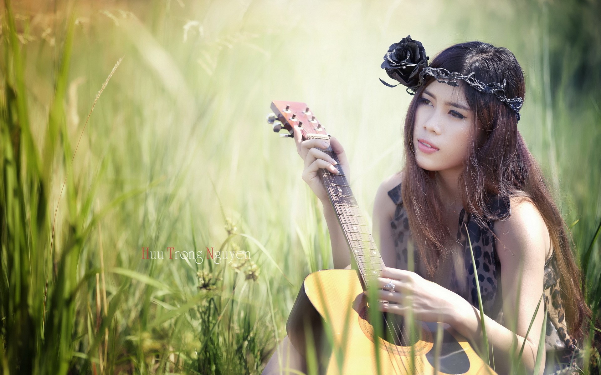 Asian woman with guitar in grass HD Wallpaper
