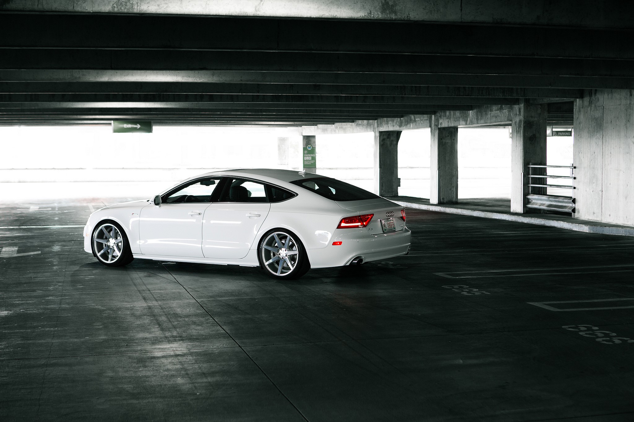 White Audi A7 parked in a concrete parking garage HD Wallpaper