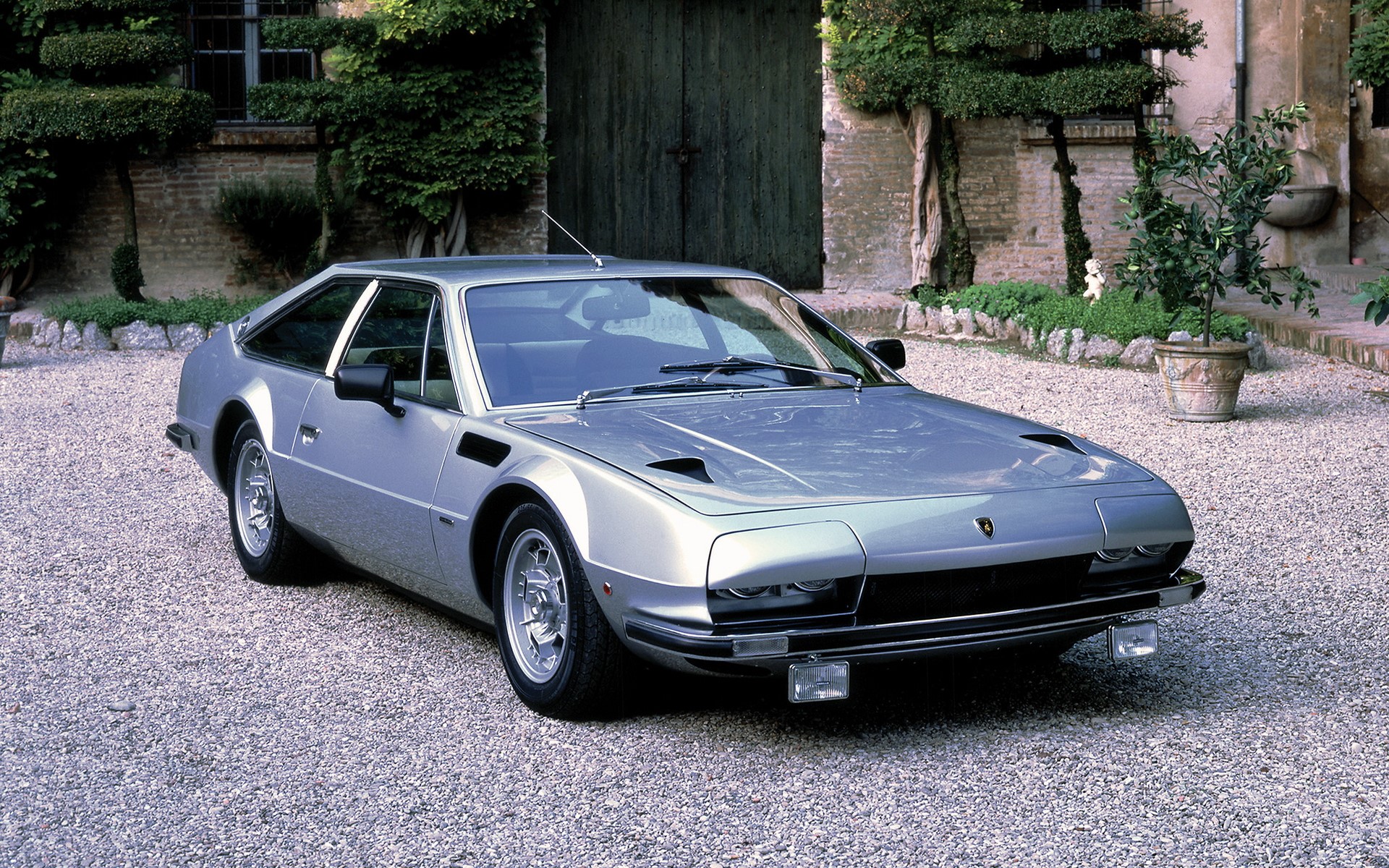 Silver Lamborghini Jalpa parked on gravel HD Wallpaper