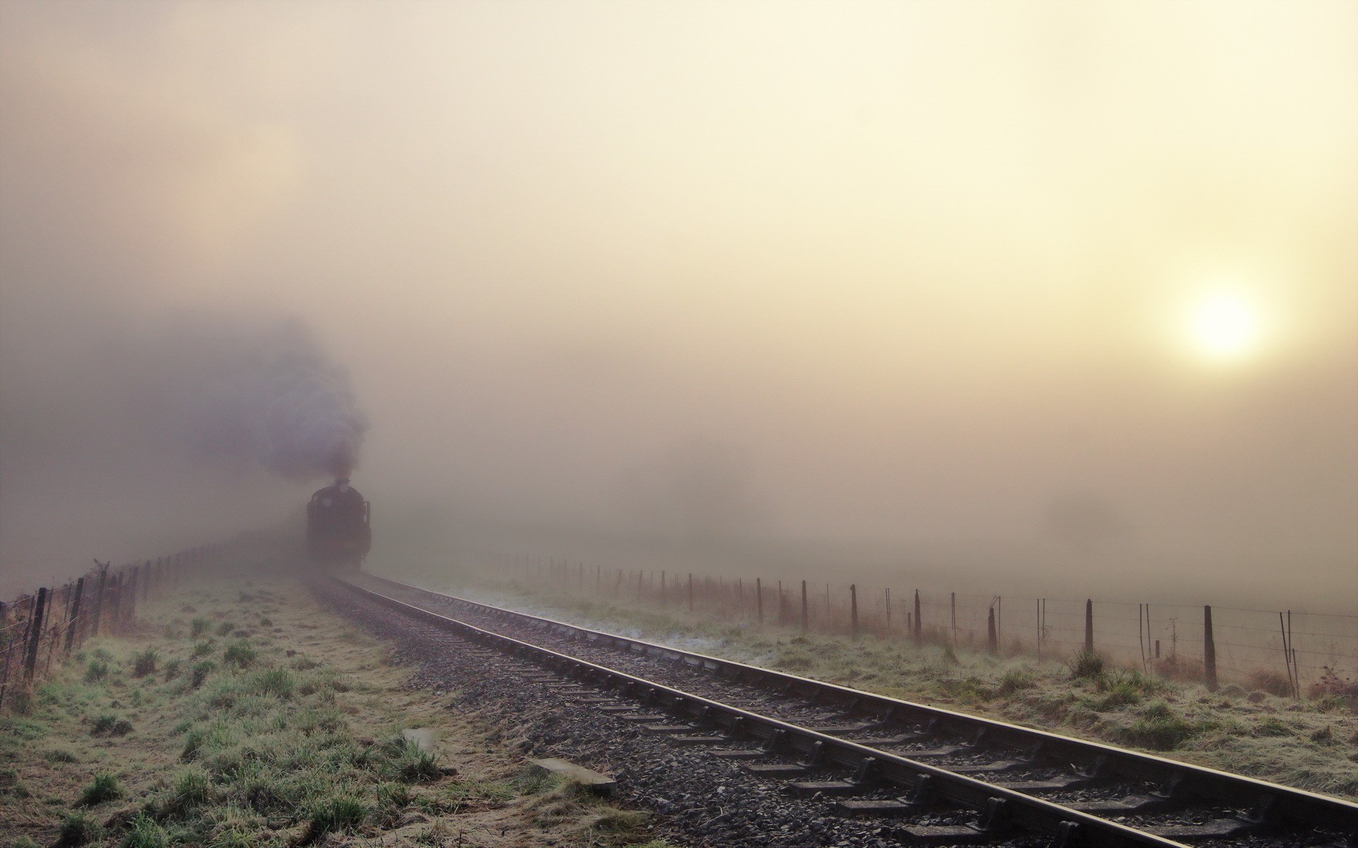 Steam train in fog on railroad tracks HD Wallpaper