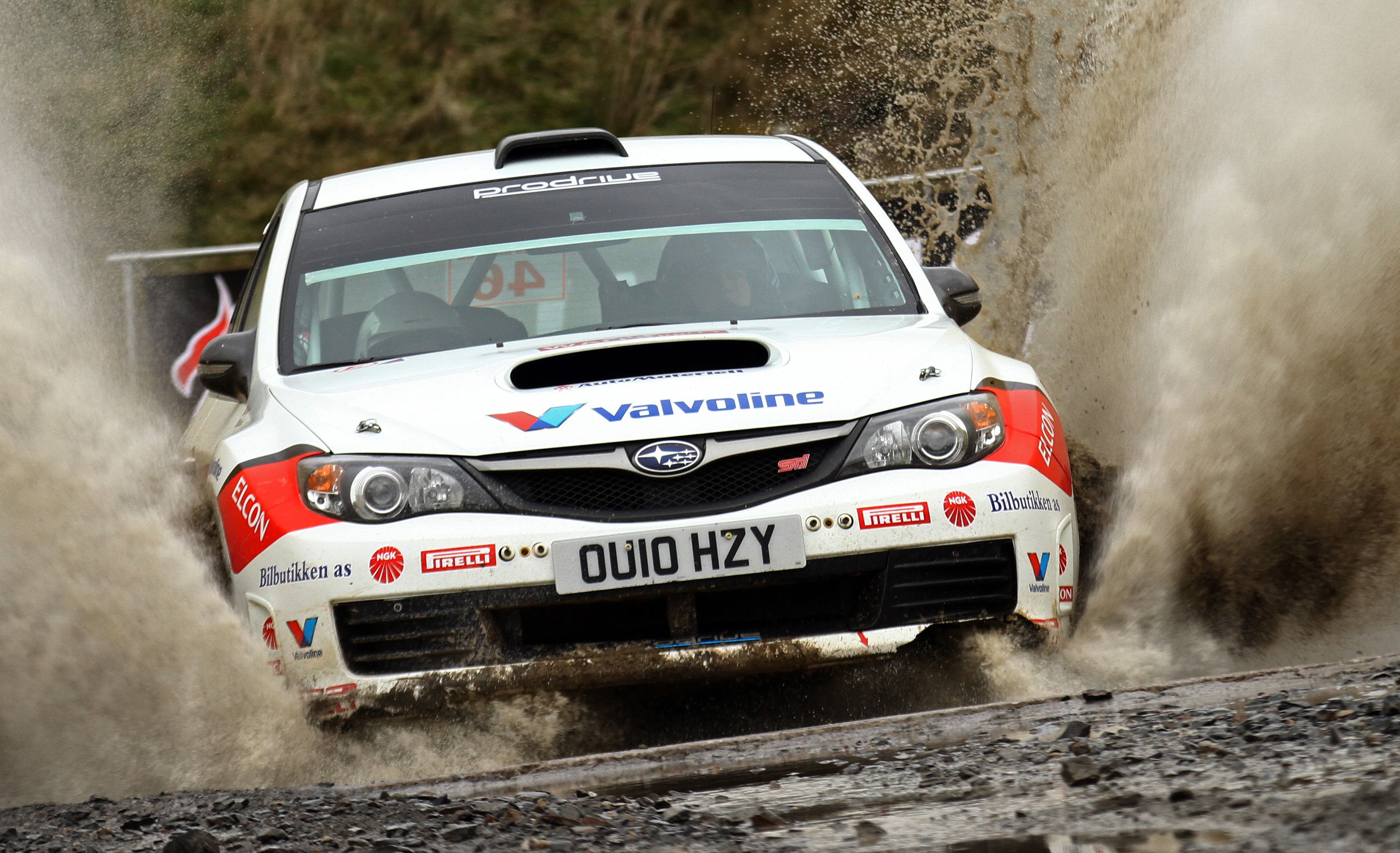 Subaru Impreza rally car driving through water splash HD Wallpaper
