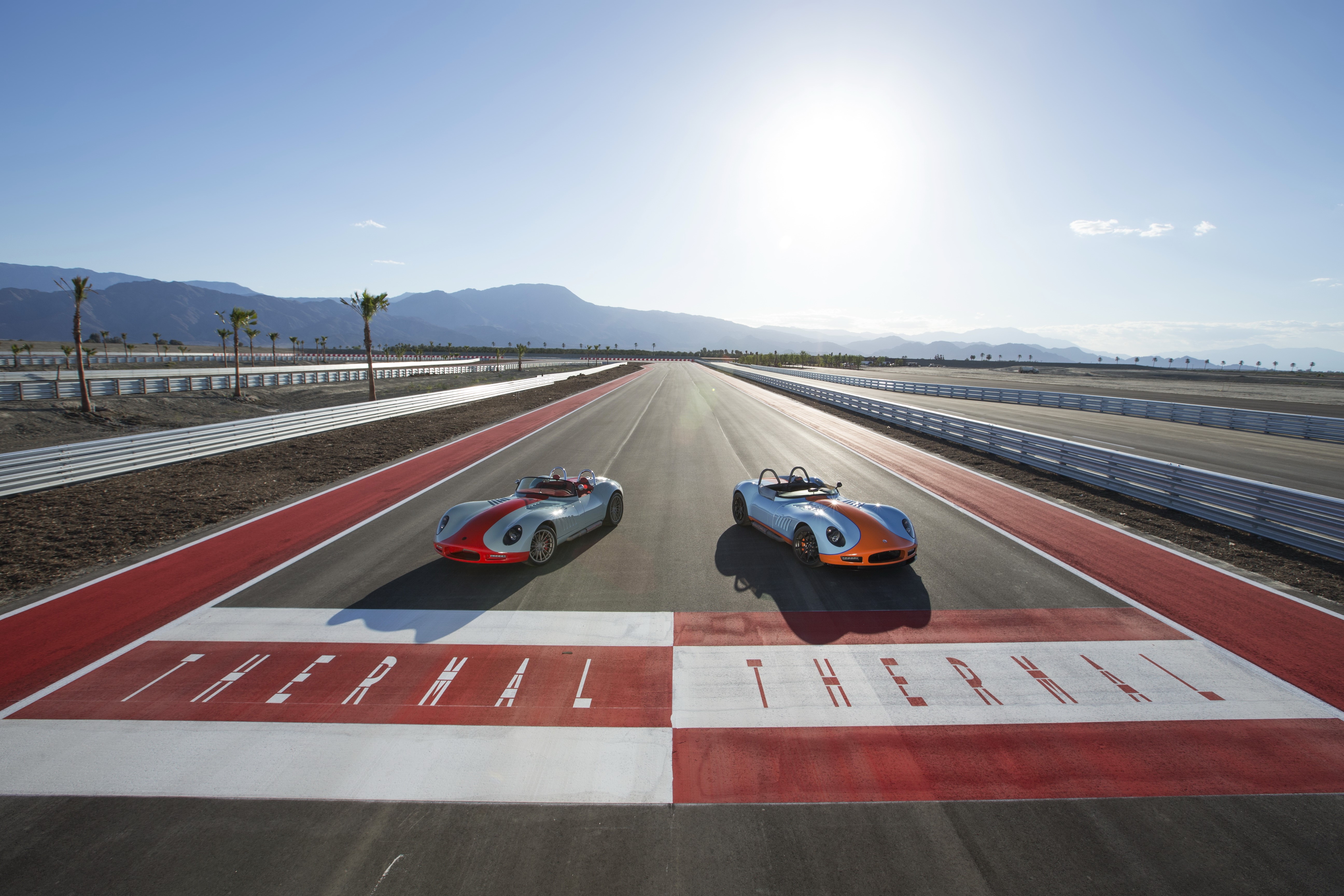 Two 2012 Lucra LC470 cars on a racetrack HD Wallpaper