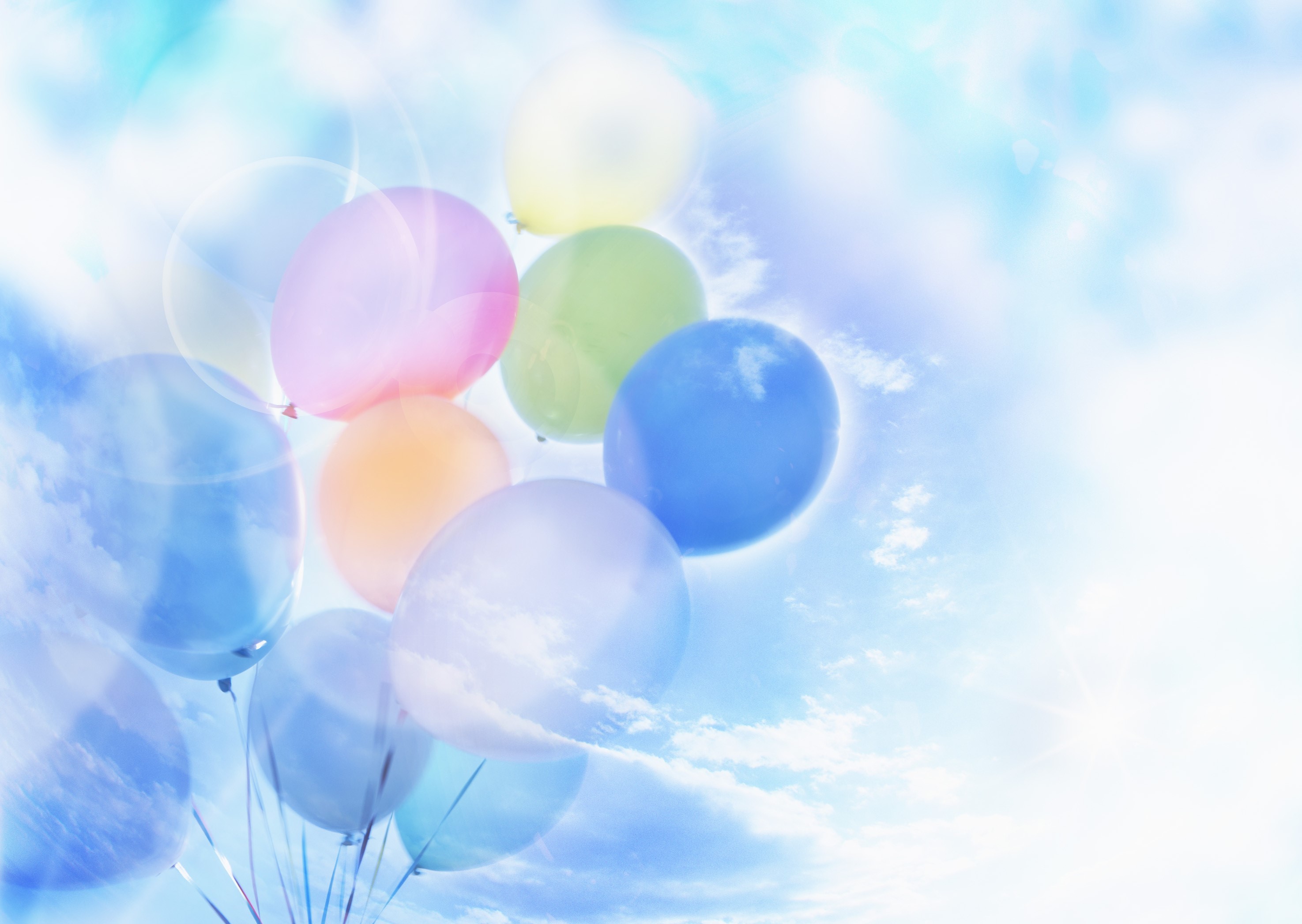 Balloons floating in a bright blue sky with clouds HD Wallpaper