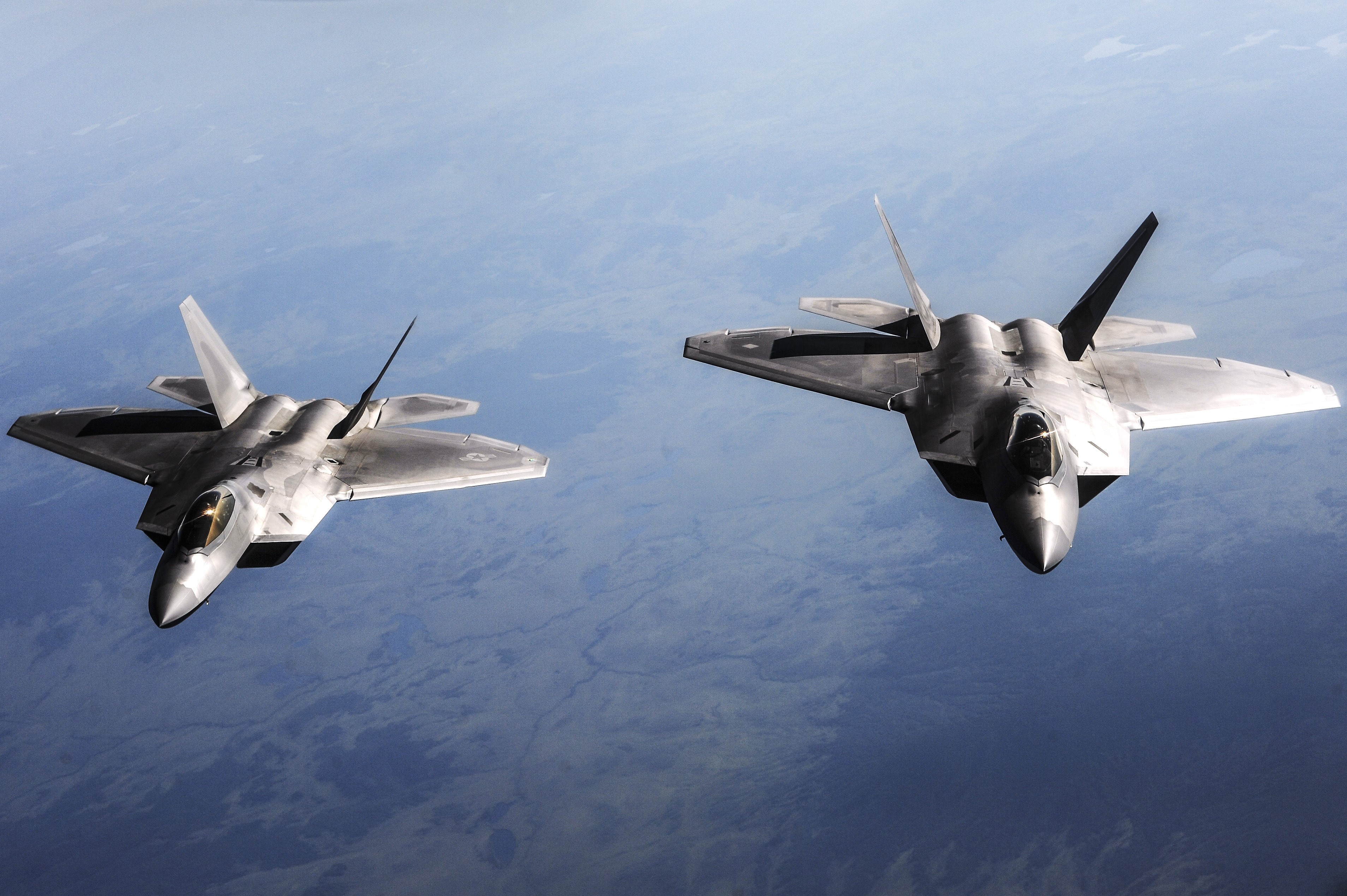 Two F-22 fighter jets flying in formation HD Wallpaper
