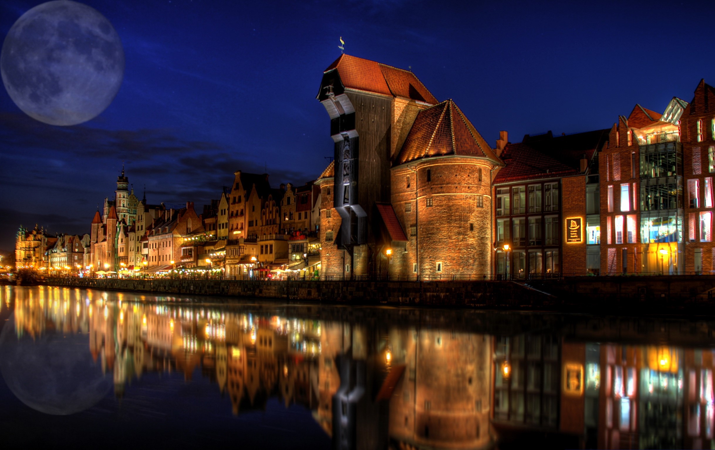 Gdańsk at night with a large moon over the river HD Wallpaper