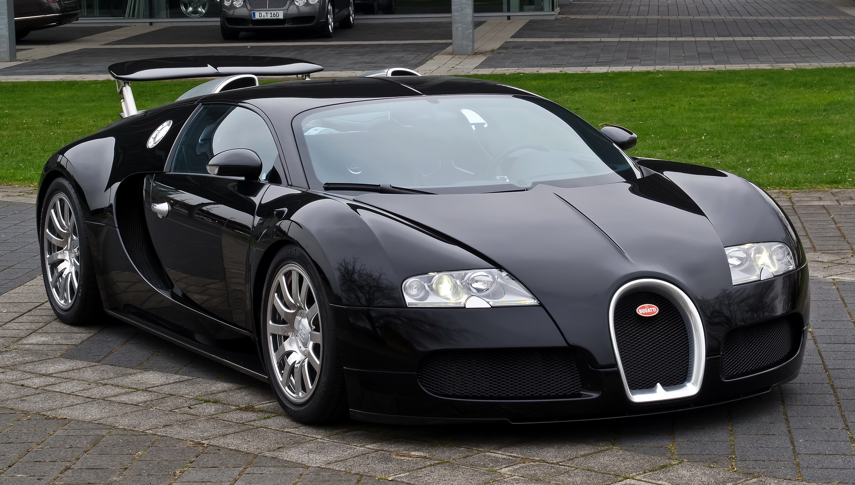 Black Bugatti Veyron 16.4 parked on pavement HD Wallpaper