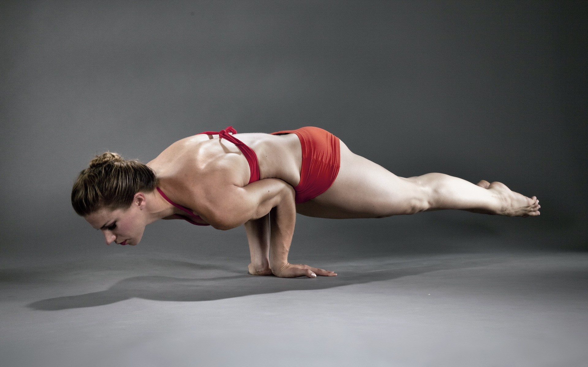 Woman performing a yoga pose on hands HD Wallpaper