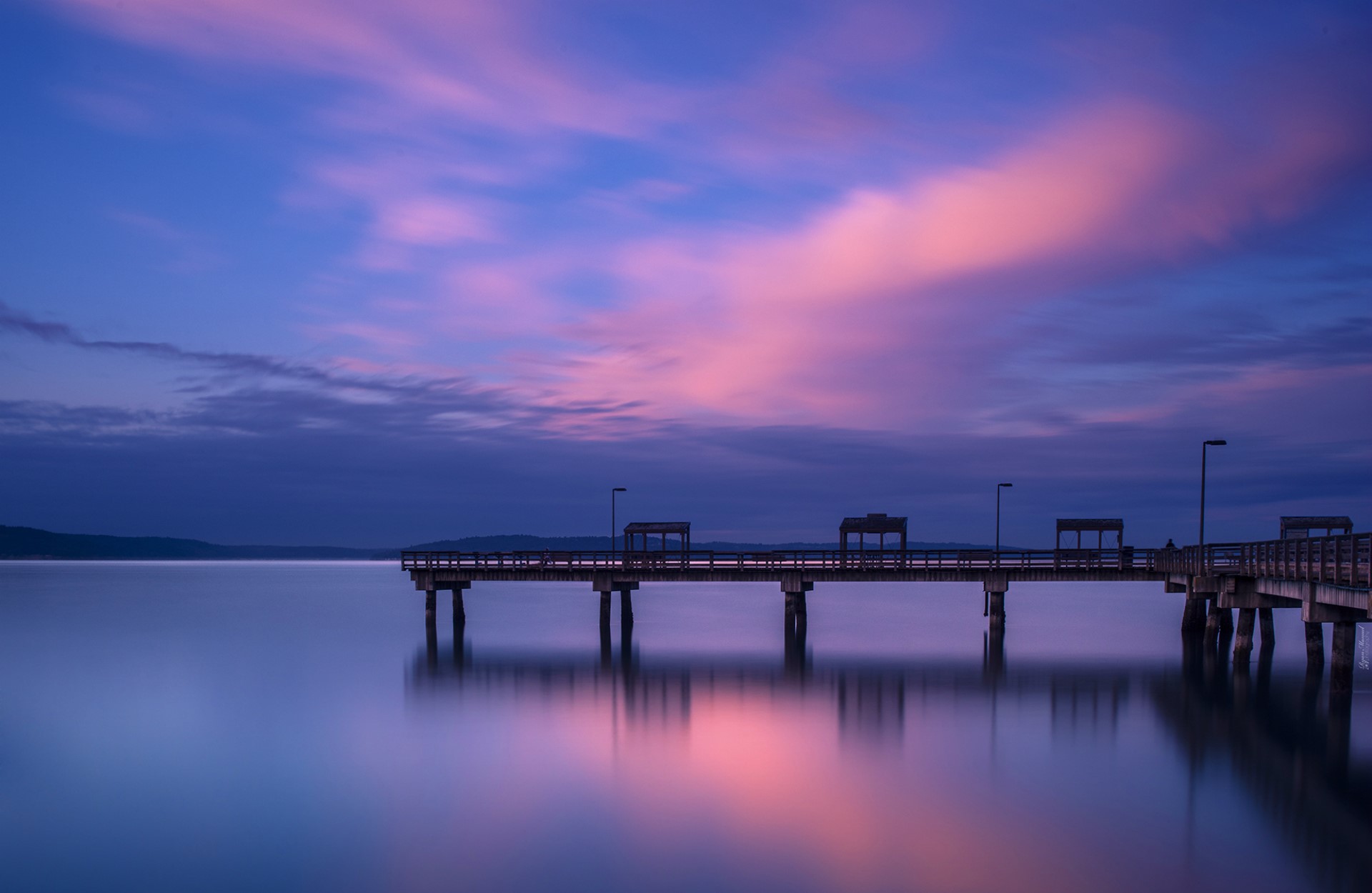 Pier over calm water at twilight with pink clouds HD Wallpaper