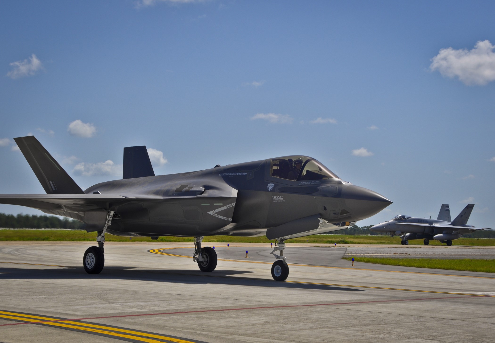 F-35 and F/A-18 fighter jets on tarmac HD Wallpaper