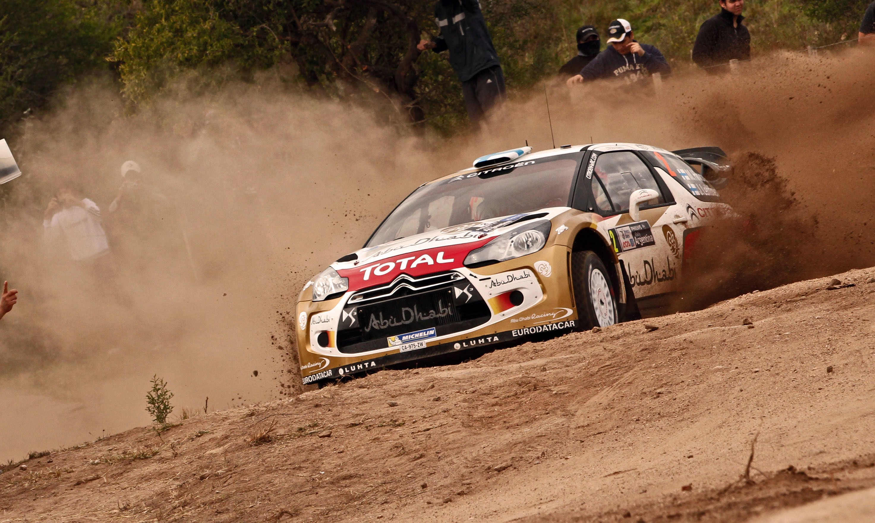 Citroen DS3 rally car kicking up dust on a dirt track HD Wallpaper