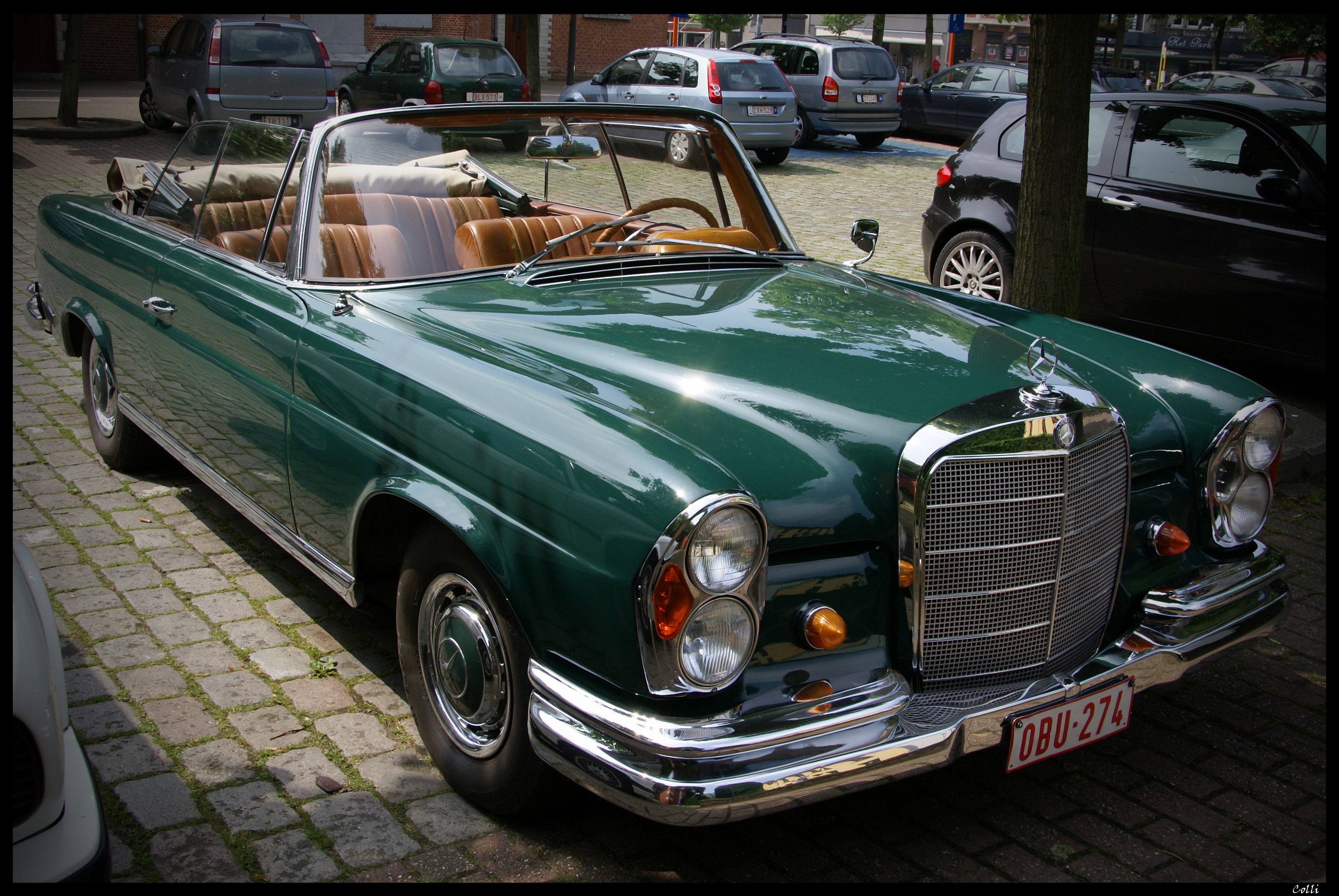 Green Mercedes-Benz 220 SE Cabriolet parked on cobblestone HD Wallpaper