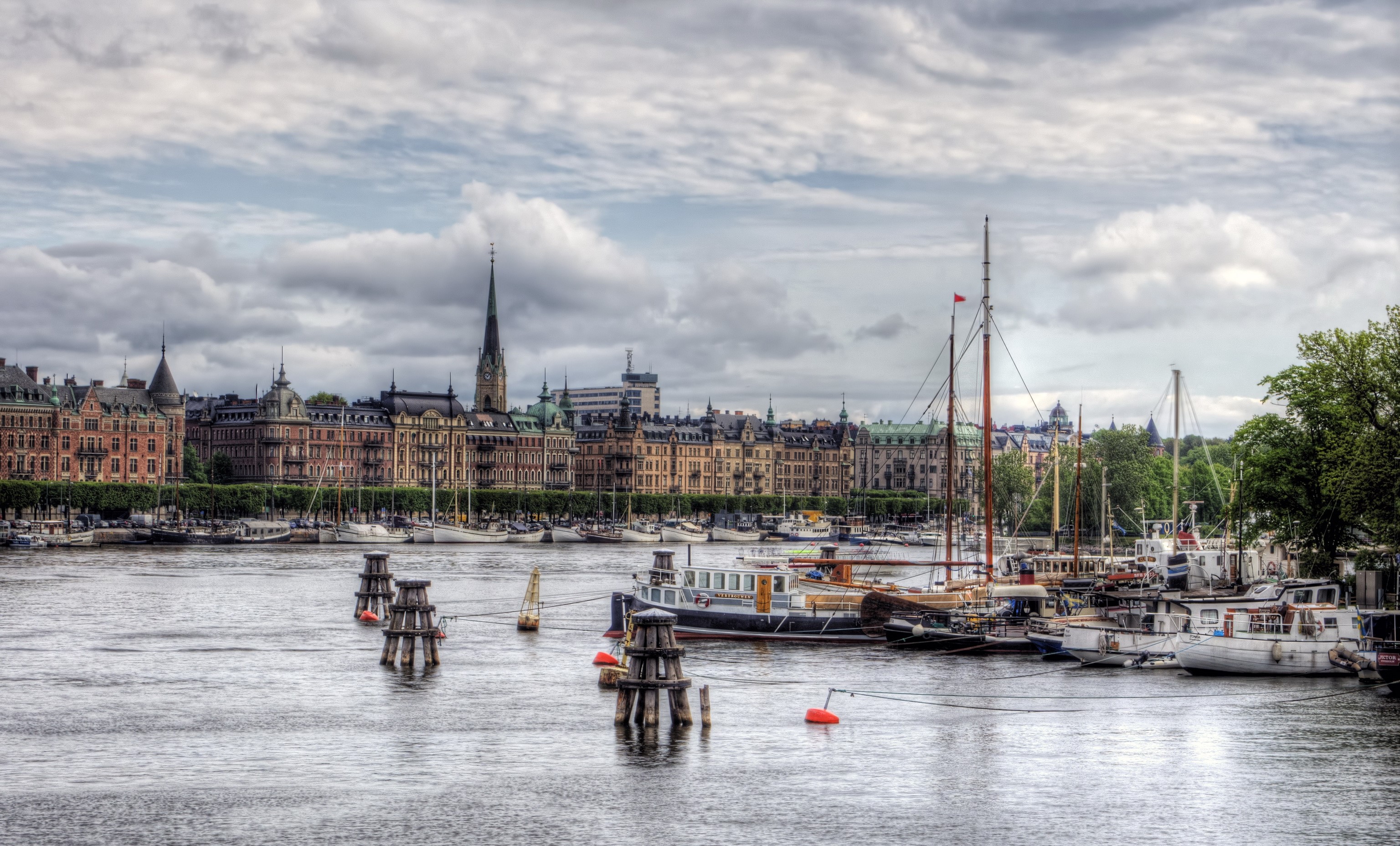 Stockholm waterfront with historic buildings and boats HD Wallpaper