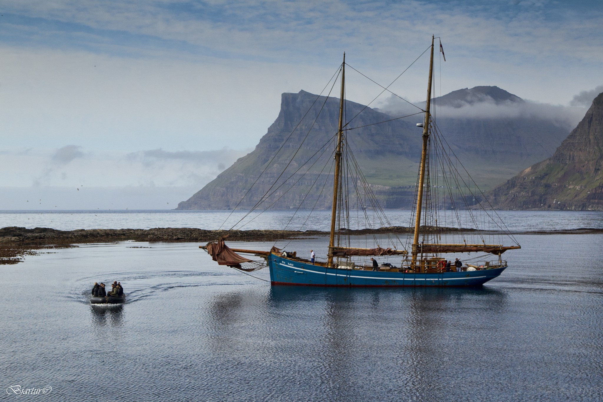 Blue sailing yacht near mountains in Faroe Islands HD Wallpaper
