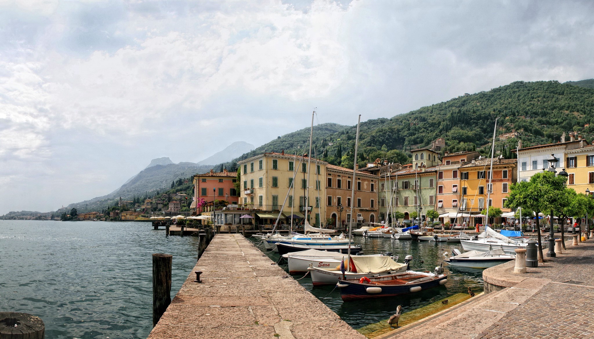 Gargnano, Italy waterfront with boats and buildings HD Wallpaper