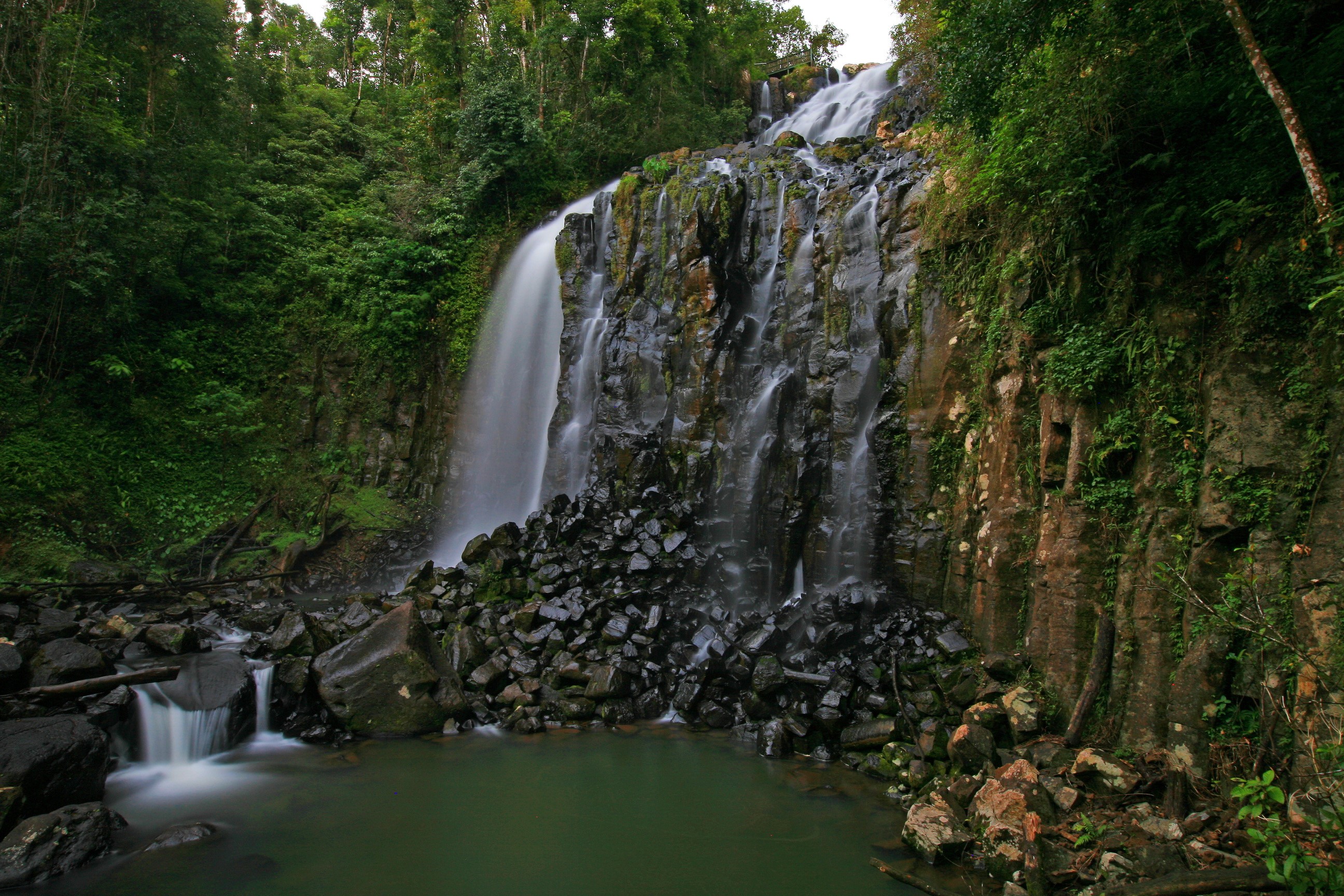 Waterfall cascading over rocks in Queensland, Australia HD Wallpaper