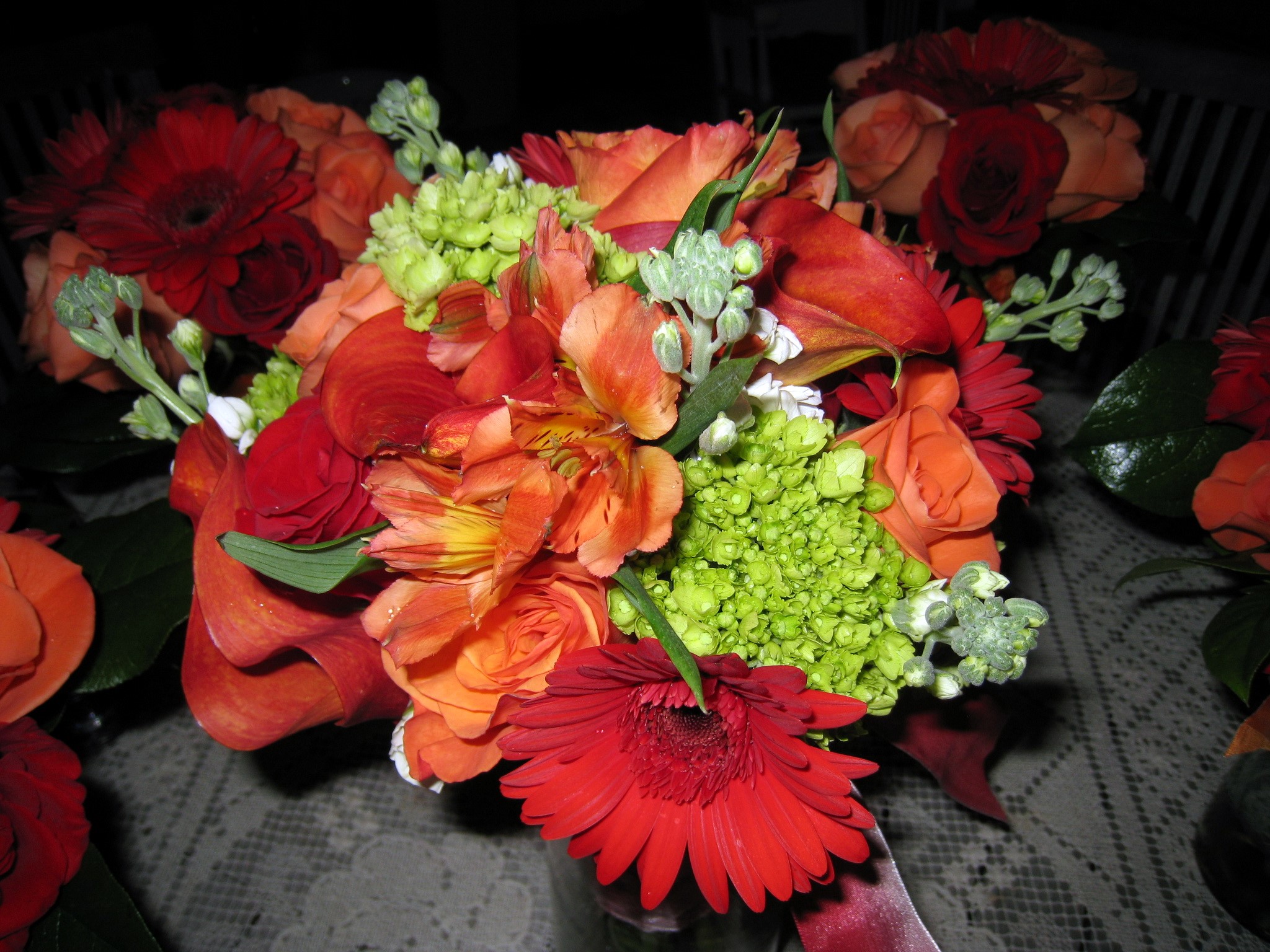 Orange and red flower bouquets with green accents HD Wallpaper