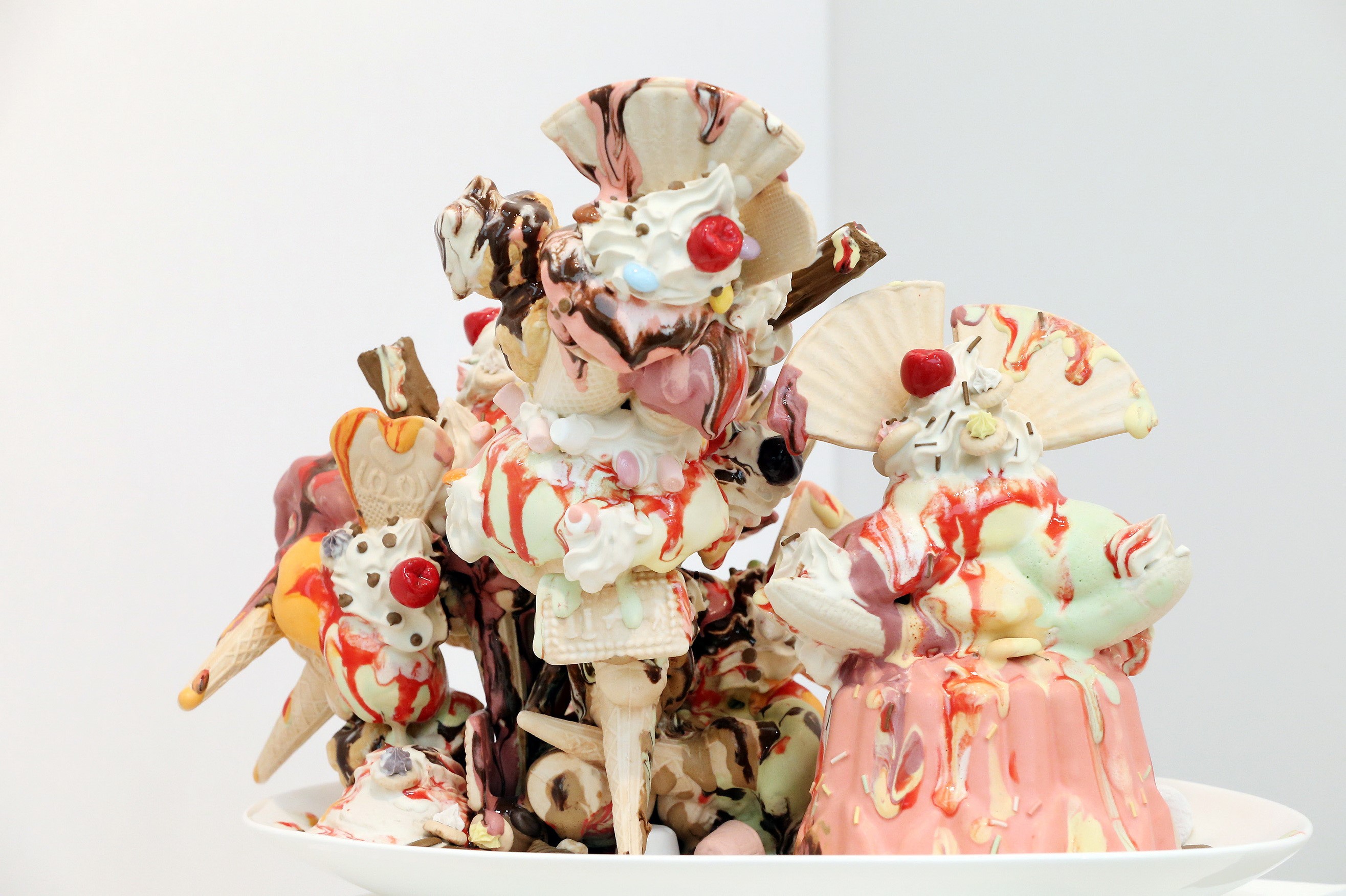 Sculpture of melting ice cream sundaes with cherries and cones HD Wallpaper