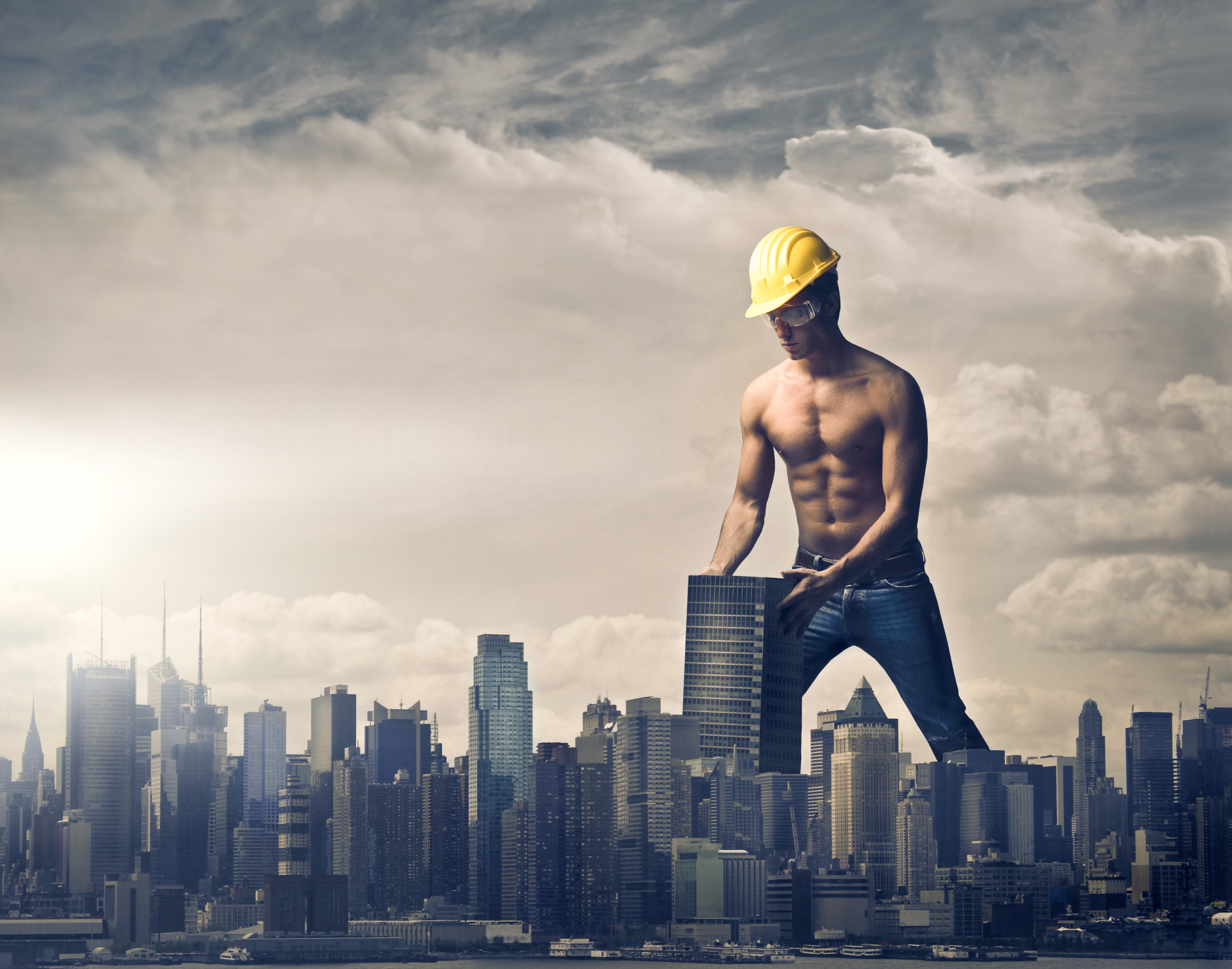 Giant man in hard hat building city HD Wallpaper
