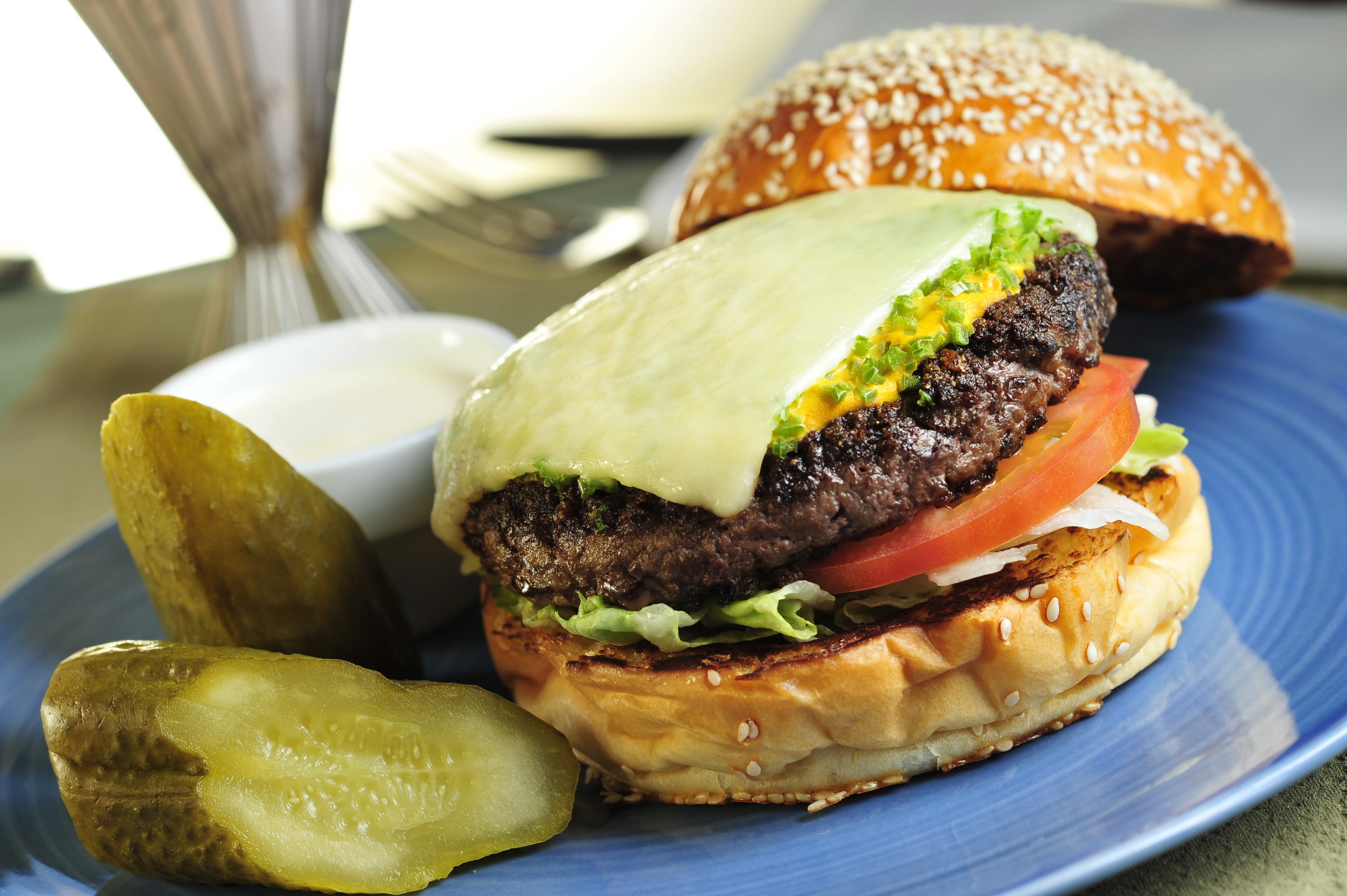 Cheeseburger with pickles and dipping sauce HD Wallpaper