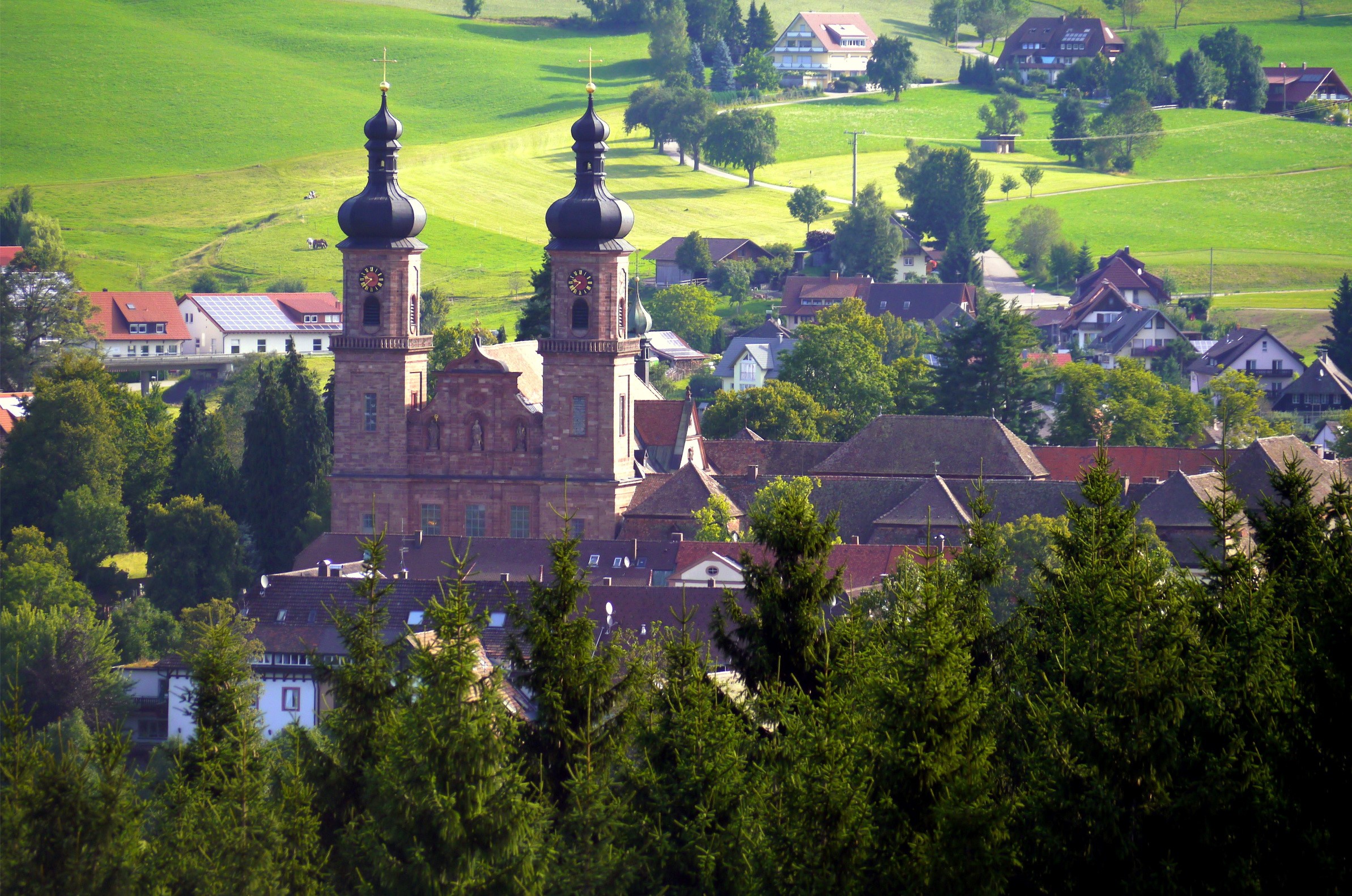 St. Peter's Abbey in Germany with rolling green hills HD Wallpaper