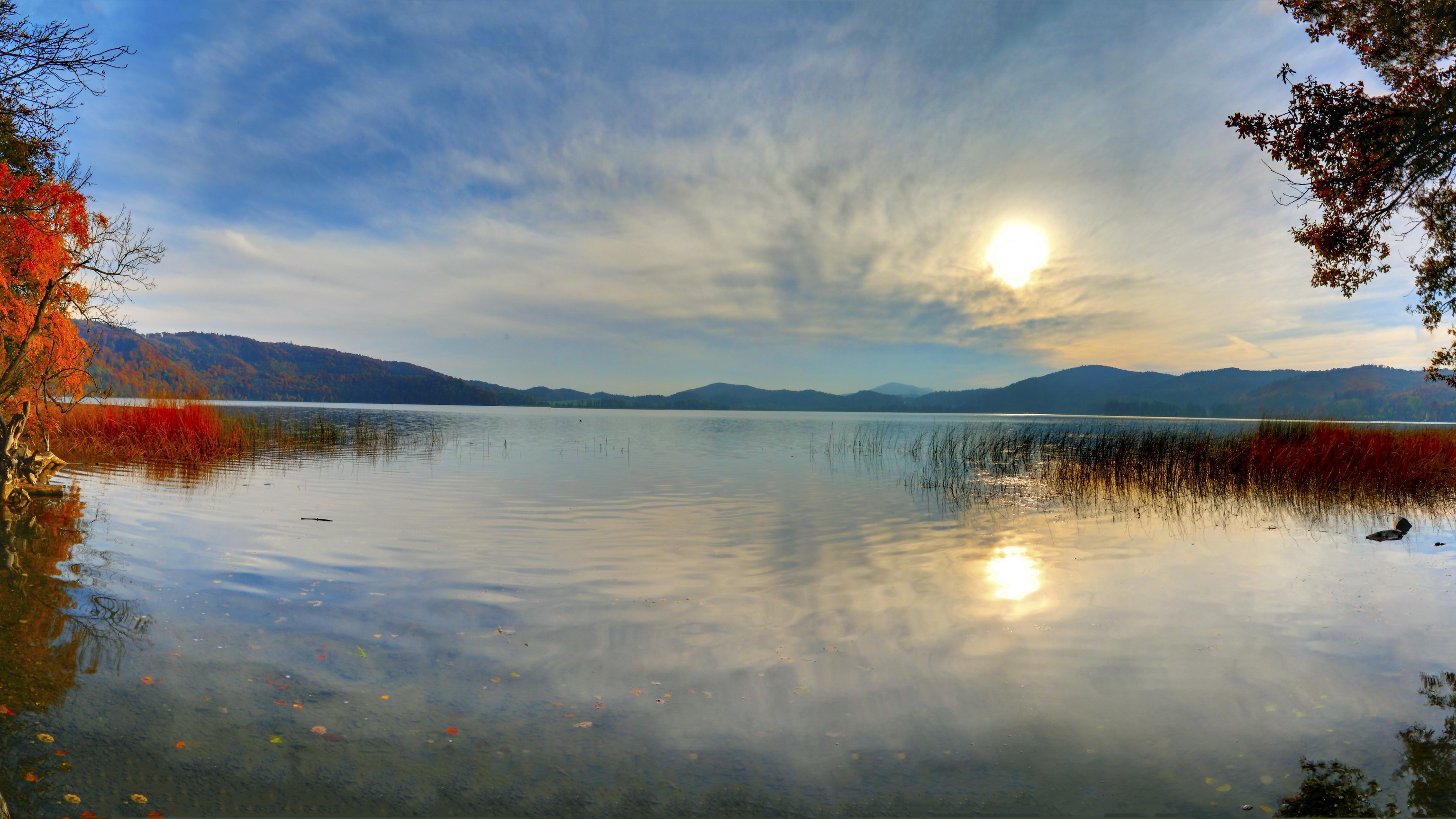 Lake with mountains and autumn foliage under a cloudy sky HD Wallpaper