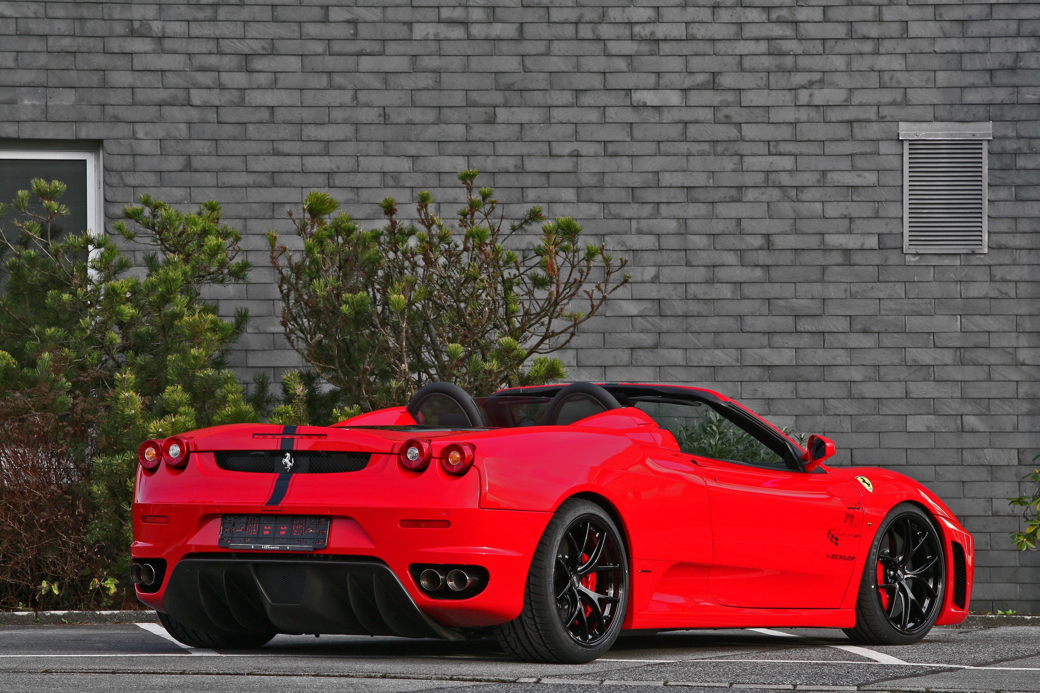 Red Ferrari F430 Scuderia Spyder parked by a brick wall HD Wallpaper