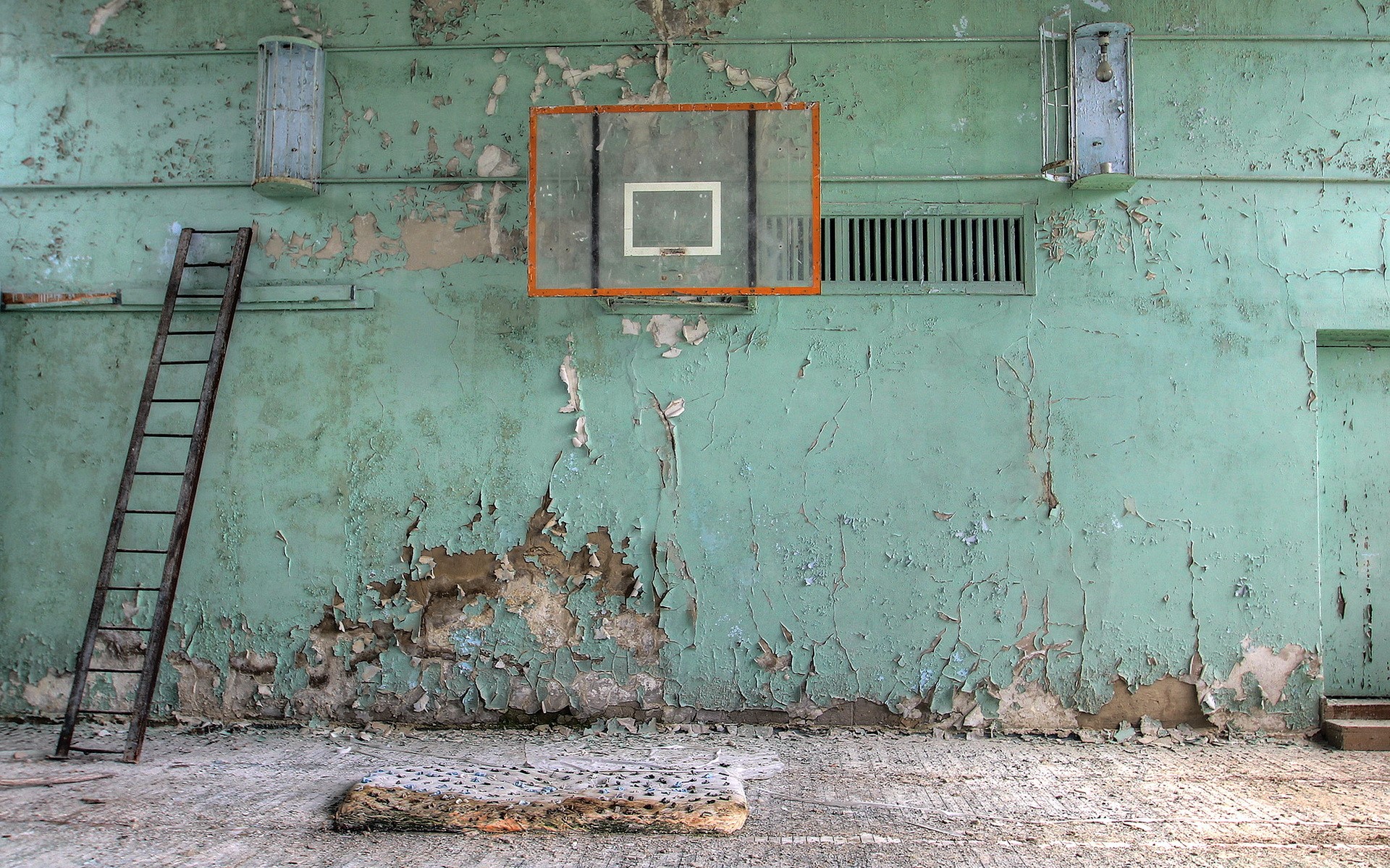 Abandoned basketball court with ladder and peeling paint HD Wallpaper