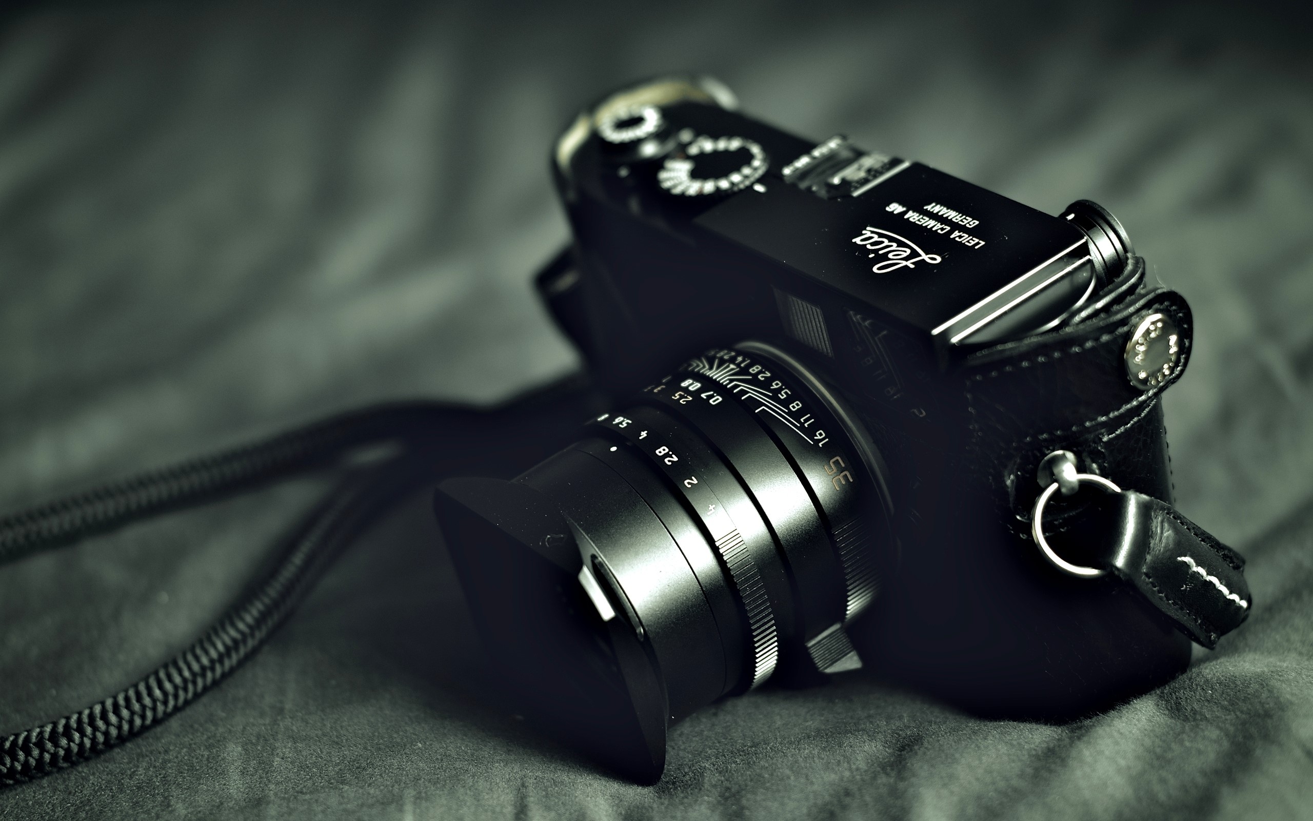 Leica camera with lens and strap HD Wallpaper