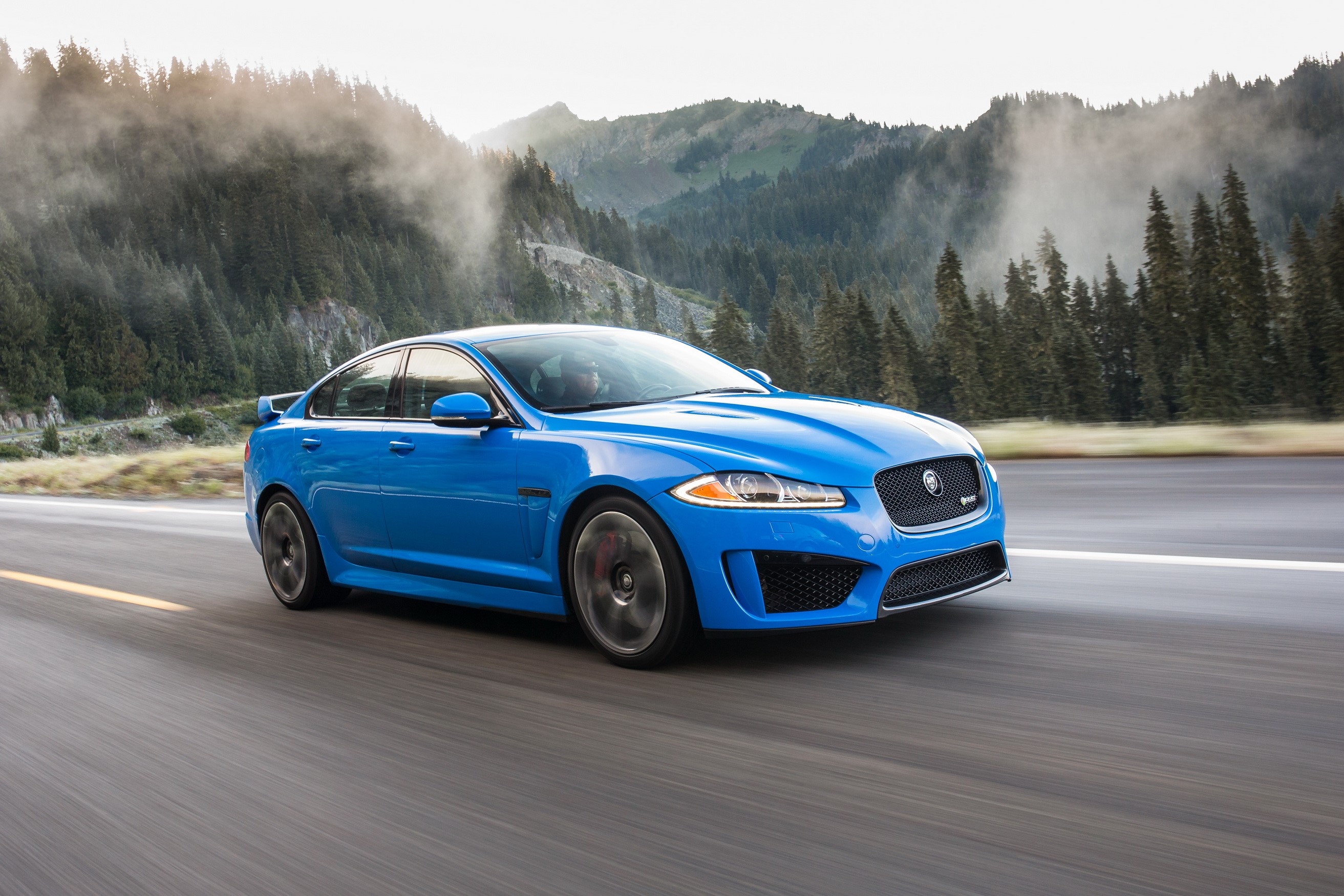 Blue 2014 Jaguar XFR-S driving on a mountain road HD Wallpaper