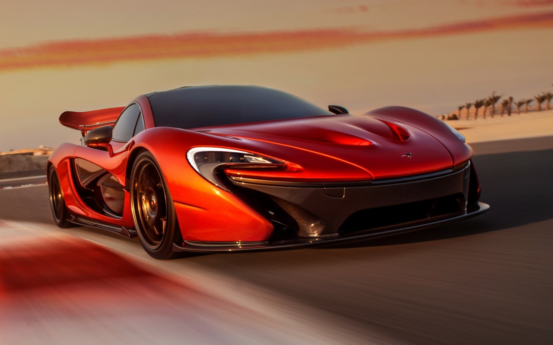 Red McLaren P1 supercar on a desert road HD Wallpaper