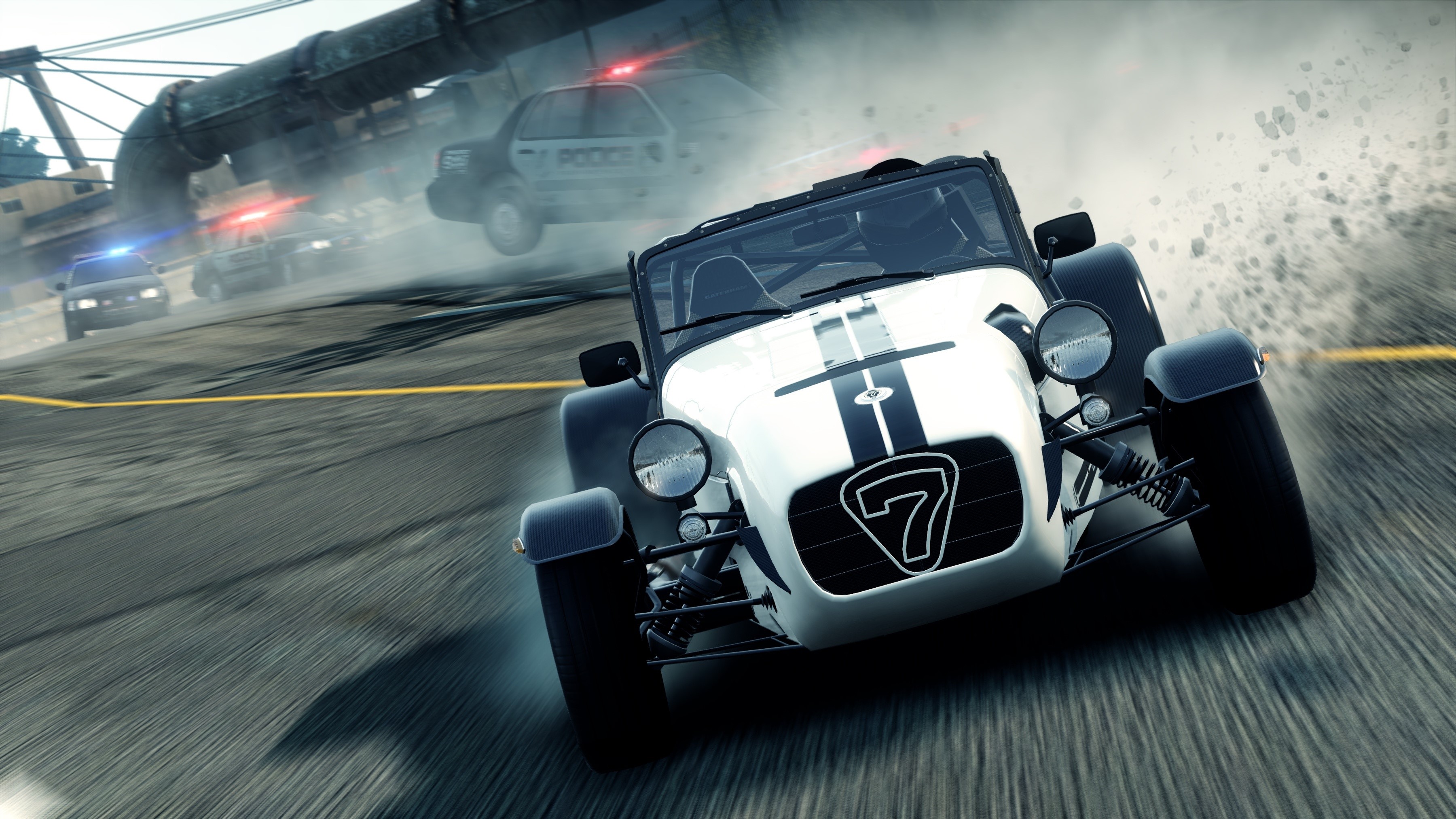 Caterham 7 pursued by police cars in Need for Speed Most Wanted HD Wallpaper